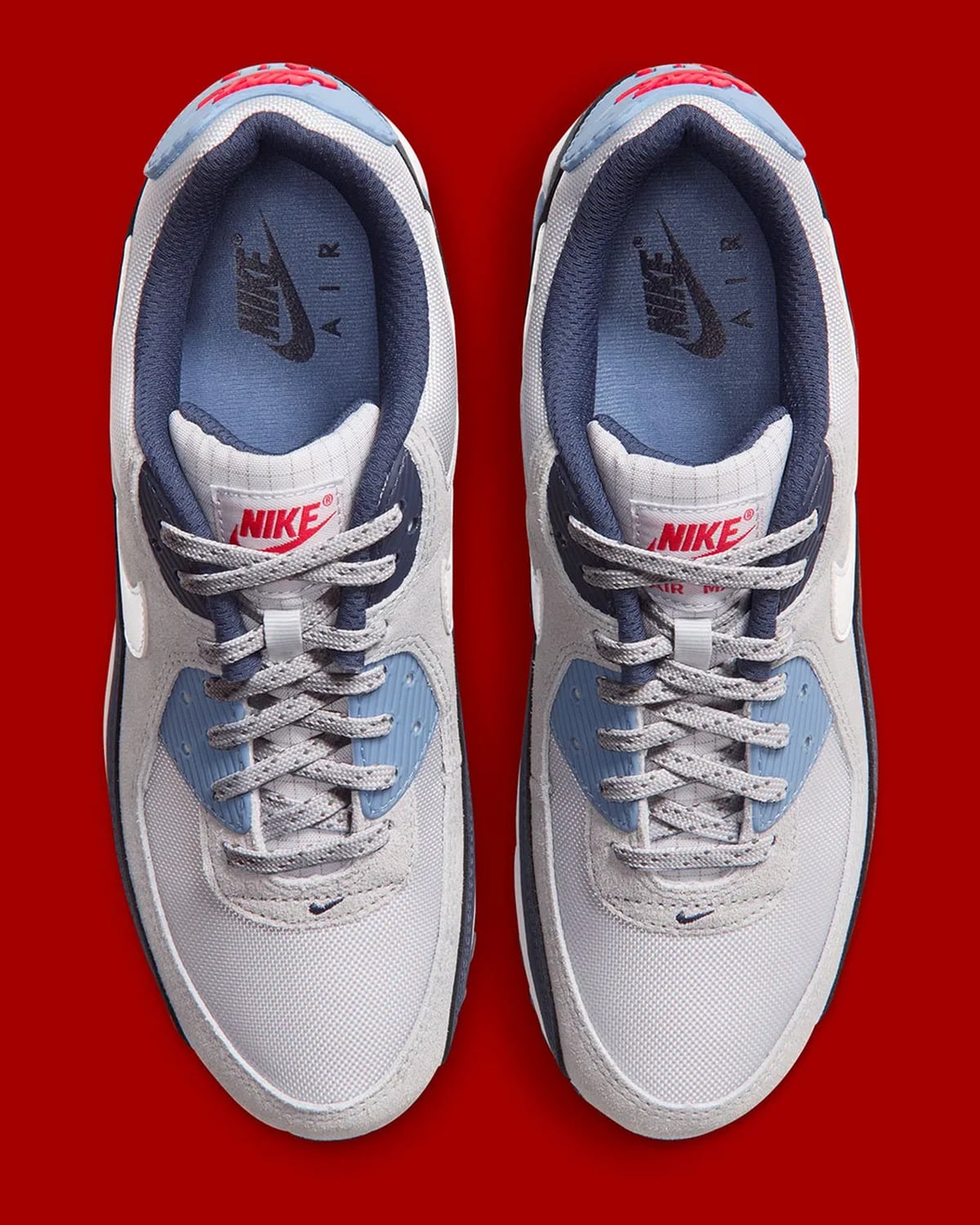 Top-down pair, grey speckled laces, red Nike tongue tag, light blue insoles, Geyser Grey
