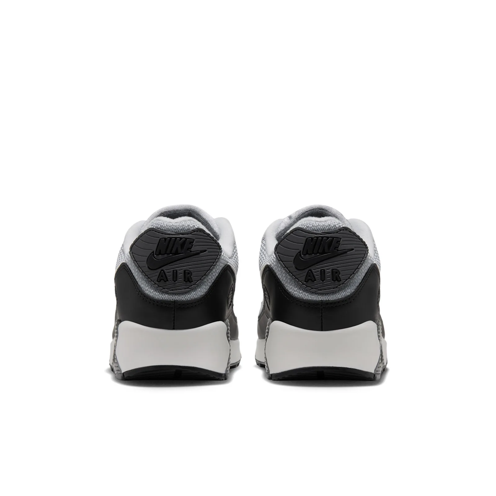 Heel view of pair, dark grey heel tabs with black Nike Air logos, black leather, pale grey midsole, Light Smoke Grey