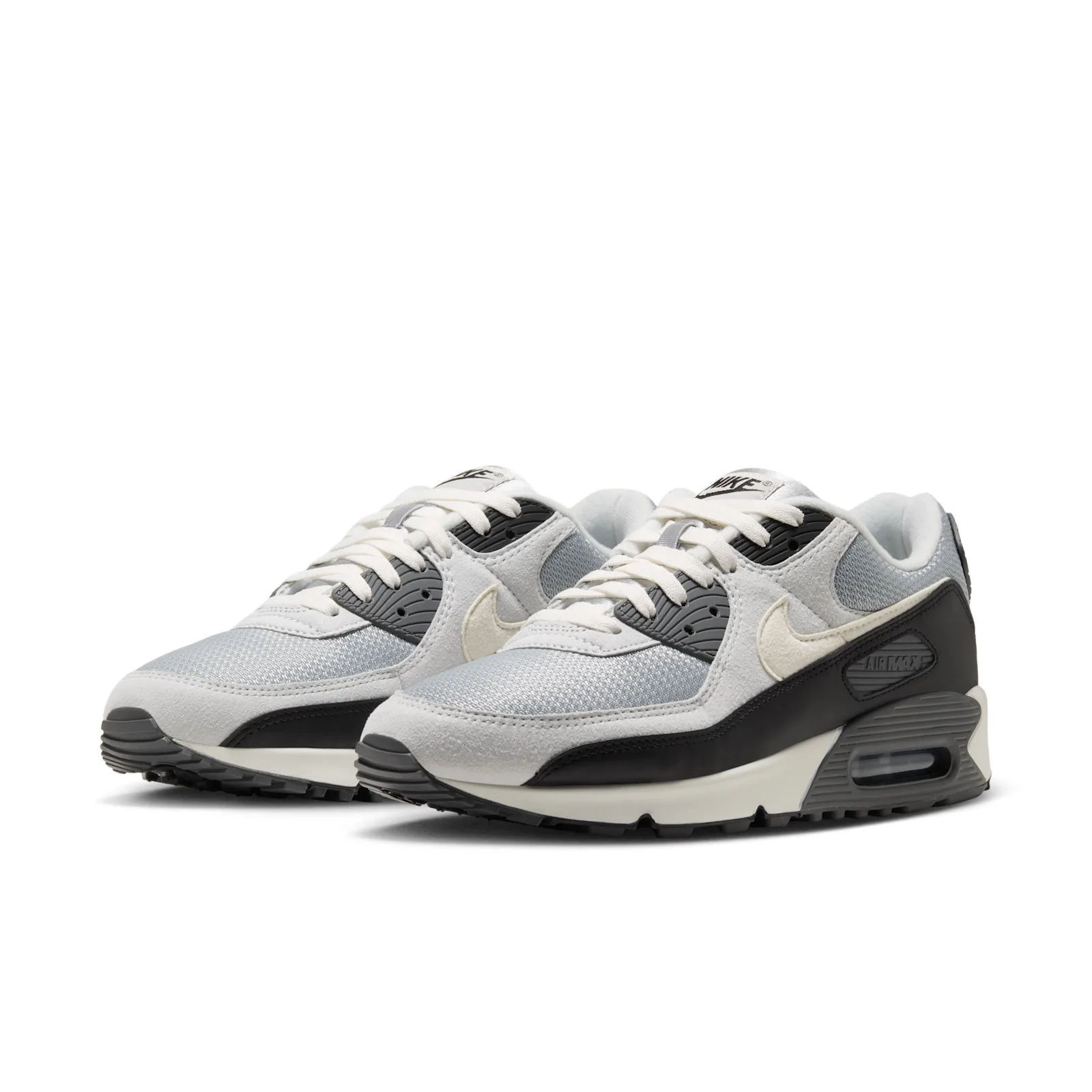 Pair at three-quarter angle, cream laces, grey mesh, black heel panels, cream swooshes, Air Max text, Light Smoke Grey