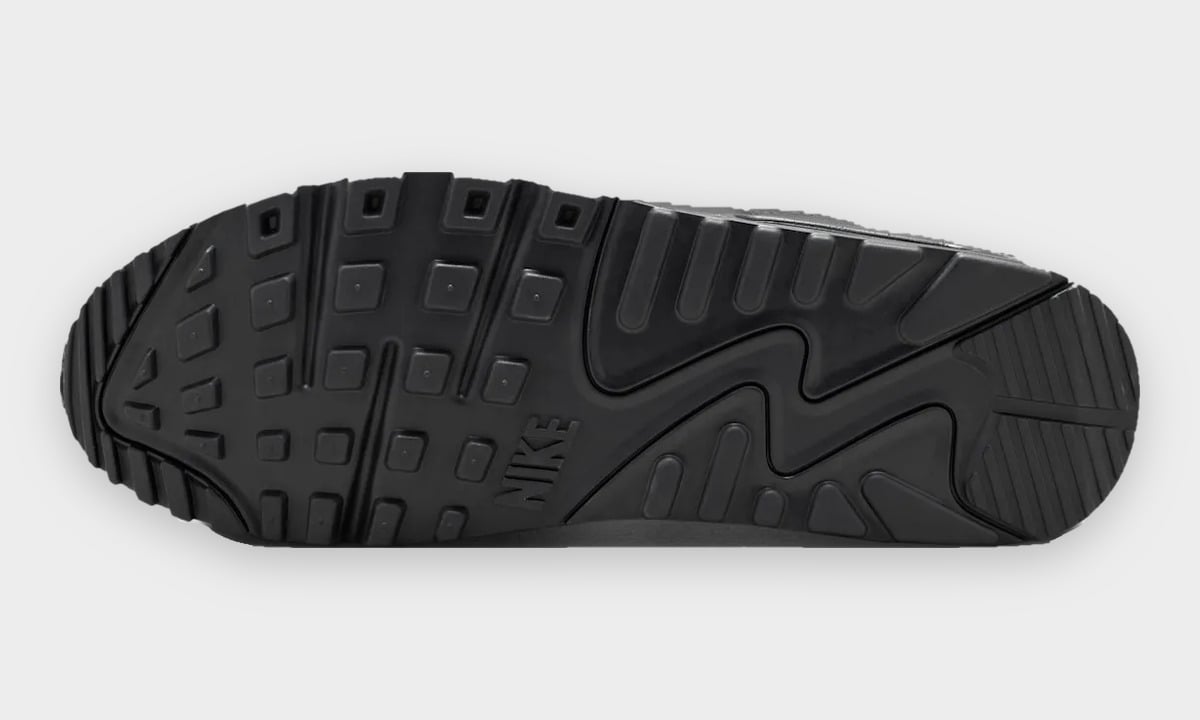 Outsole view, all-black rubber with square tread pattern and embossed Nike text, Black Leather