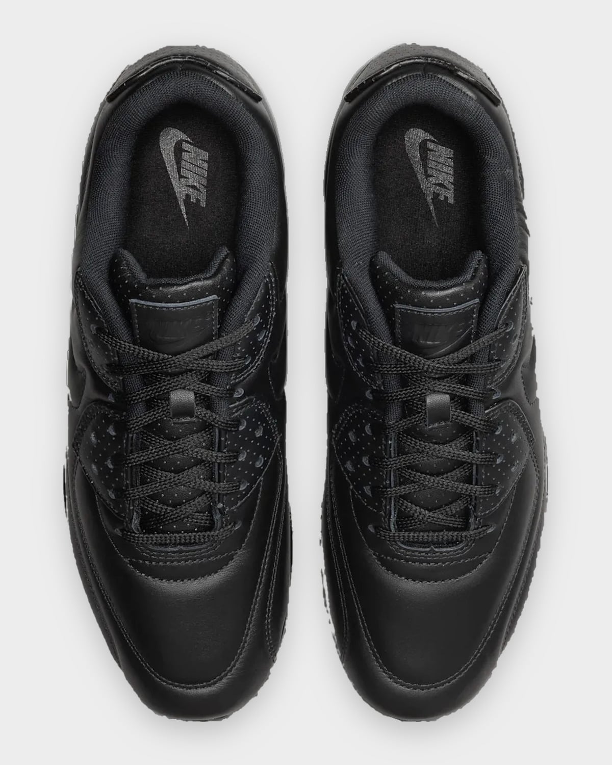 Top-down view of the pair, black laces, perforated overlays and grey Nike logos on the insoles, Black Leather