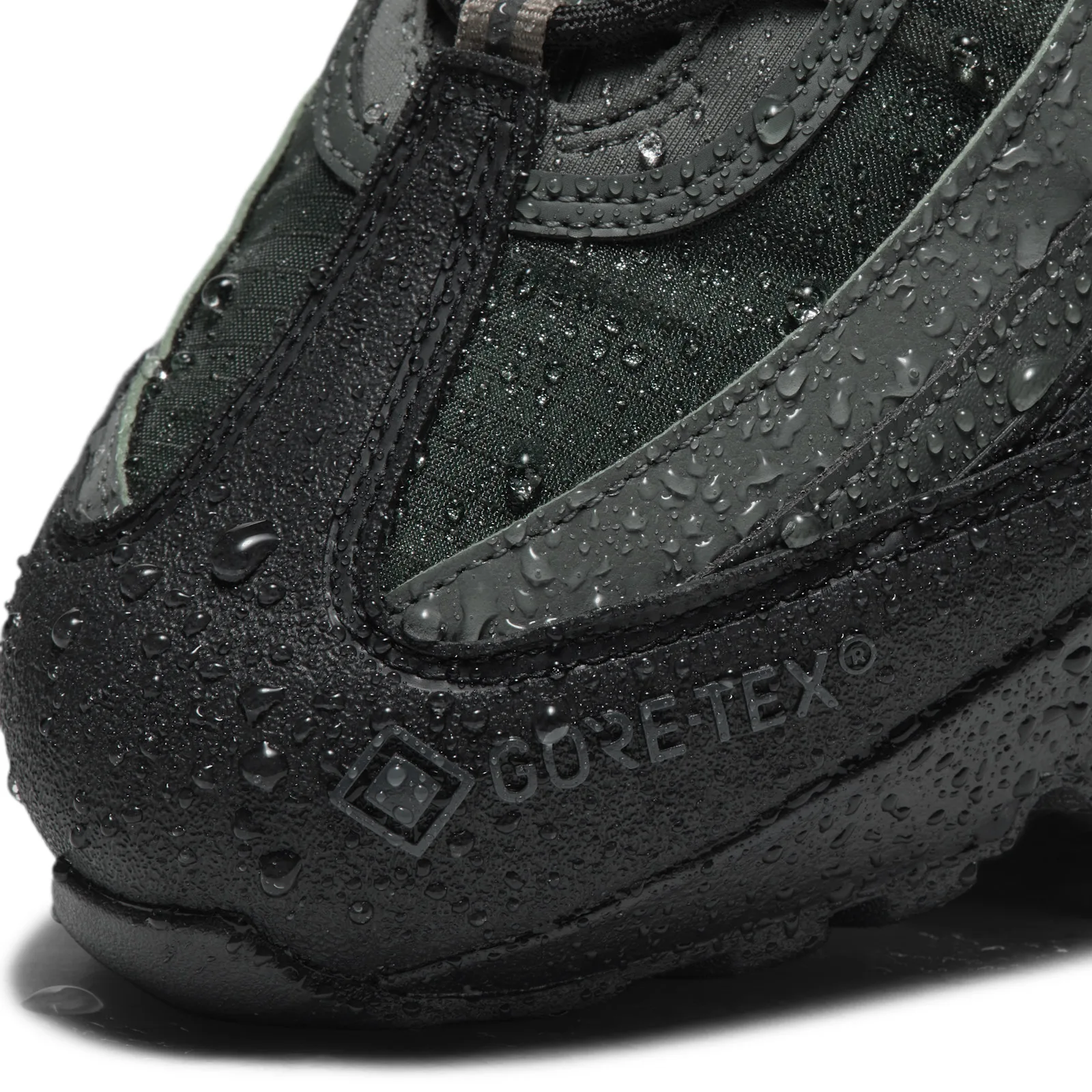 Toe detail with water droplets beading on black GORE-TEX logo and dark green ripstop, Camo Green