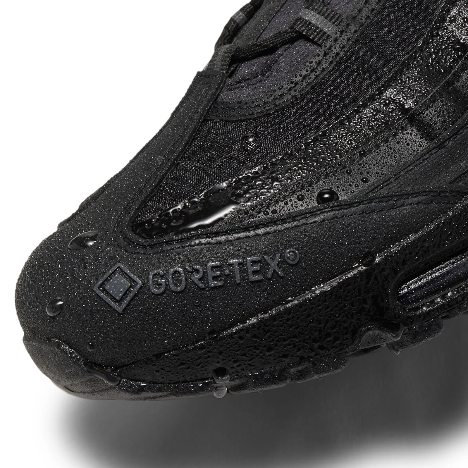 close-up of toe, Gore-Tex logo, water droplets beaded on fabric, Triple Black