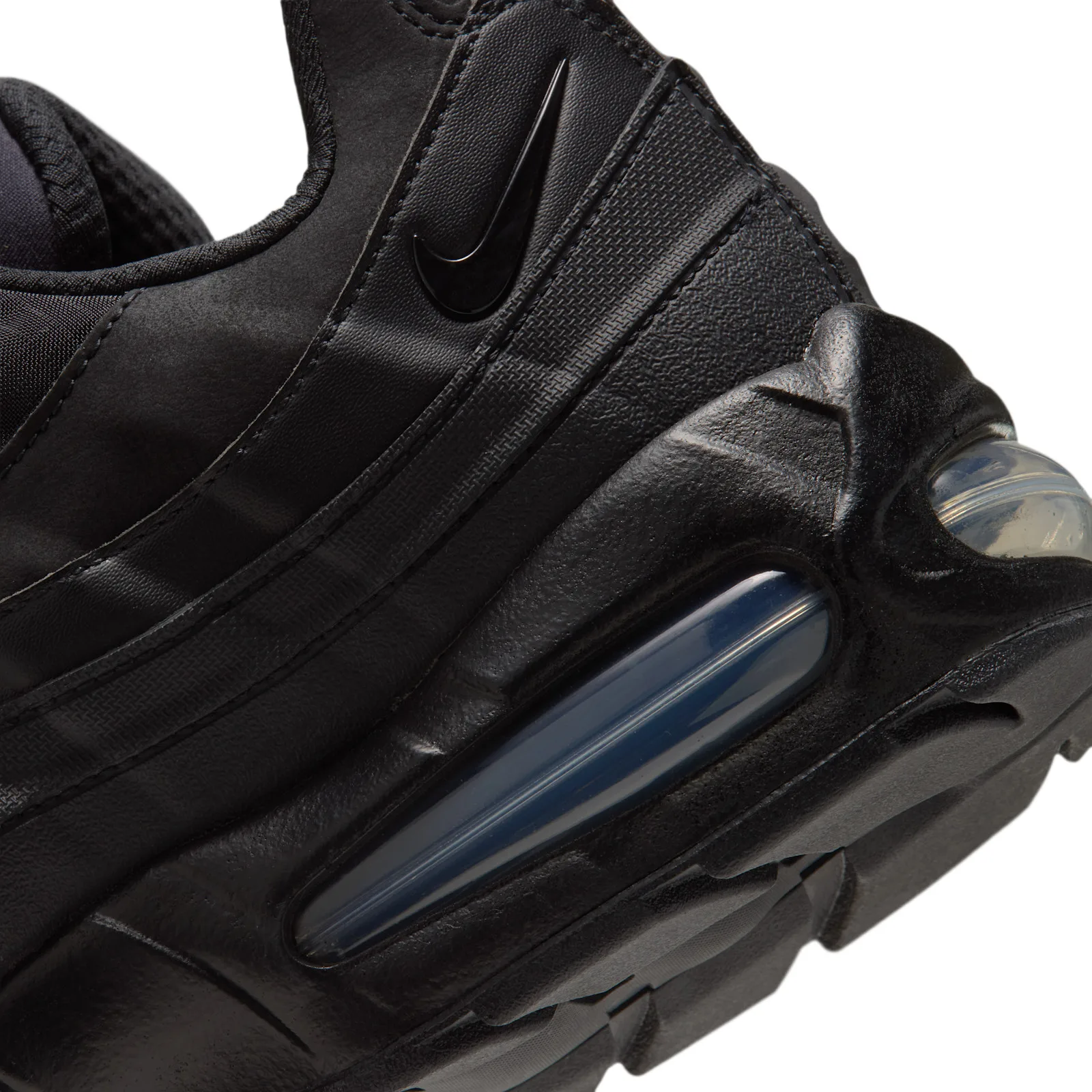 close-up of heel and navy air unit, embossed swoosh, suede texture, Triple Black