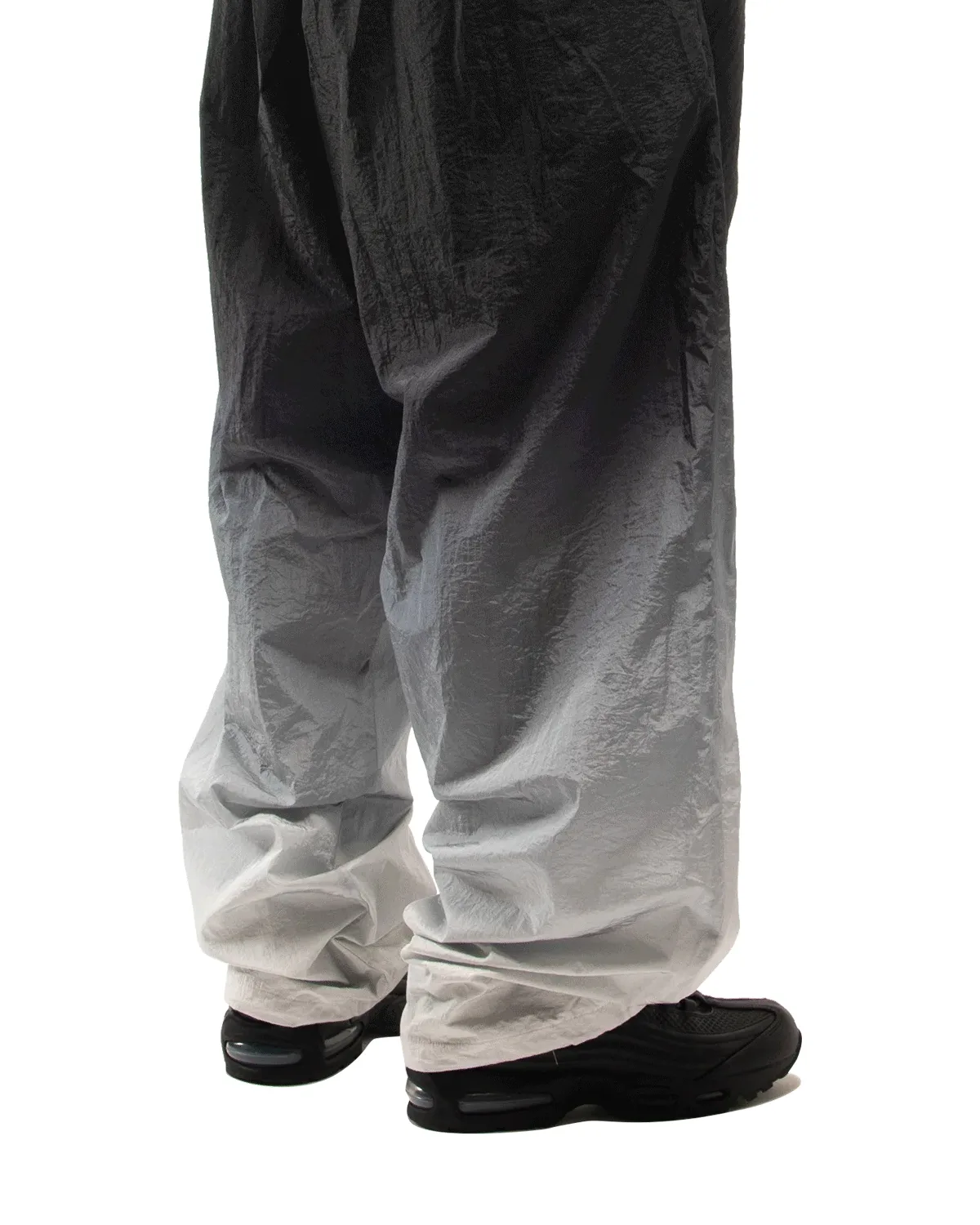 On-foot rear view, black shoes under crinkled black-to-white gradient trousers, Black