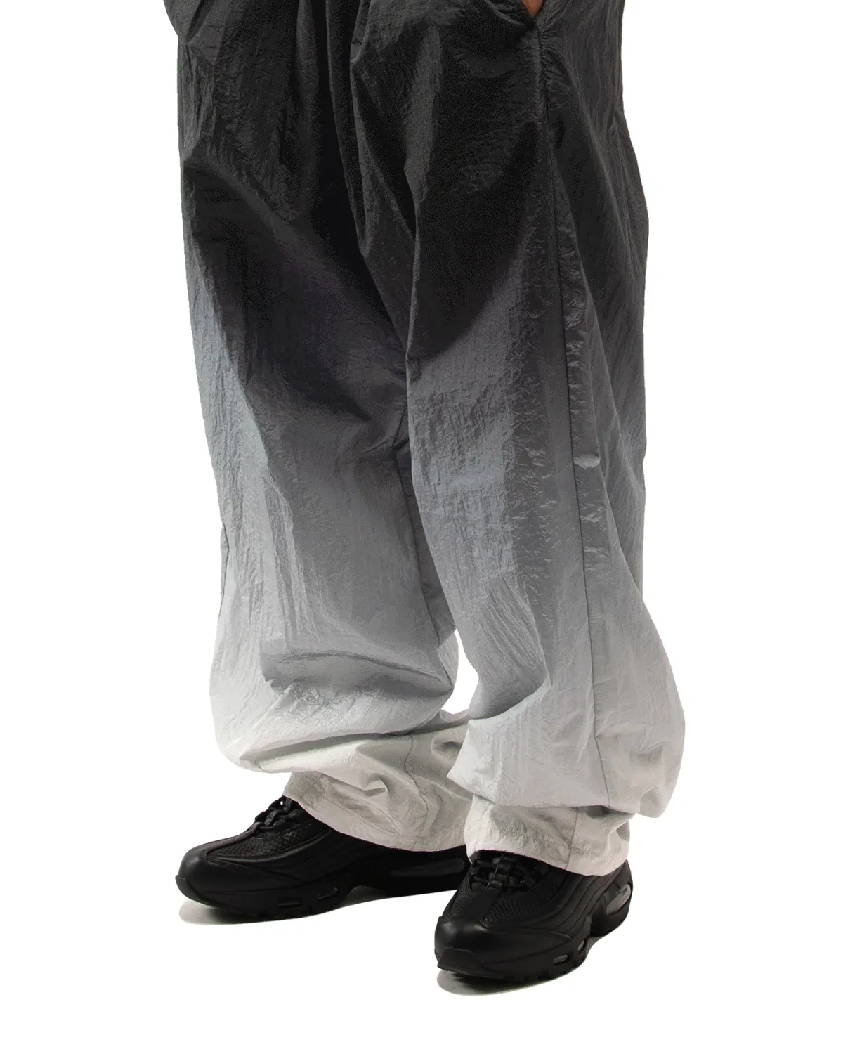 On-foot front view, black pair under wide black-to-grey-white gradient trousers, Black