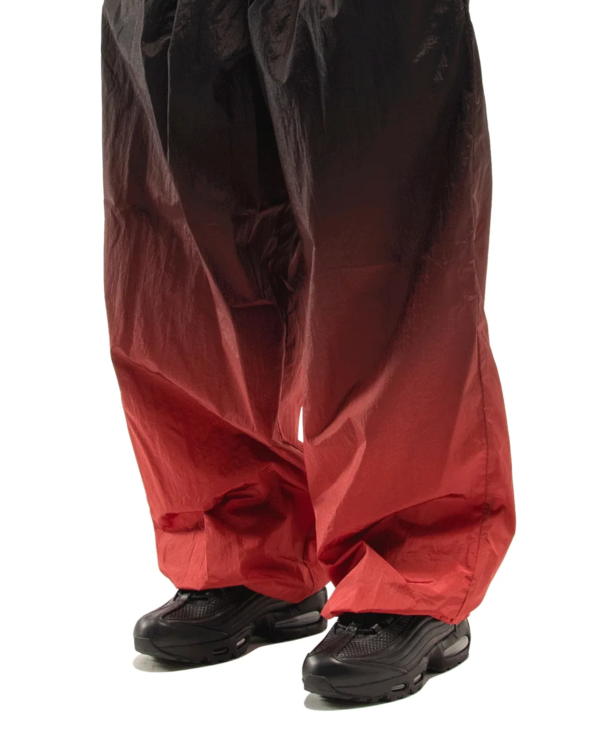 On-foot front view, black pair beneath wide black-to-red gradient crinkled trousers, Black