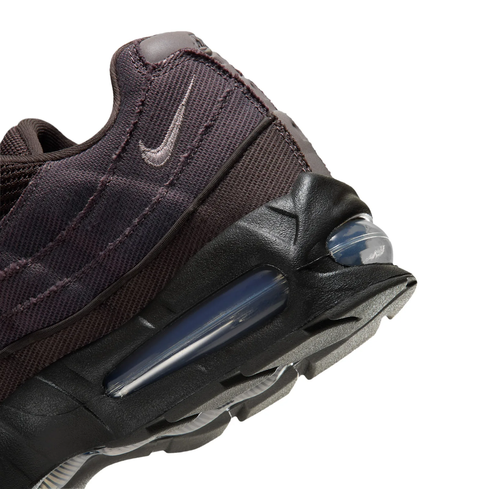 Detail of heel, frayed-edge twill panel with grey swoosh above a blue-tinted air bubble, Medium Ash