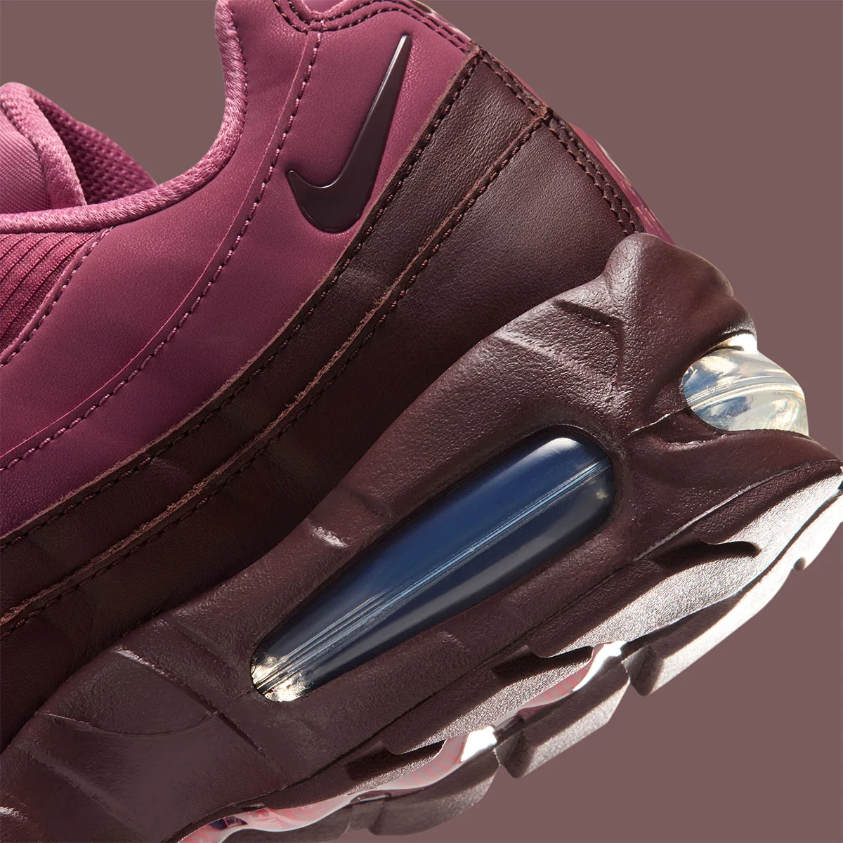 Detail of heel, burgundy swoosh on pink upper and blue air unit in brown midsole, Mystic Dates