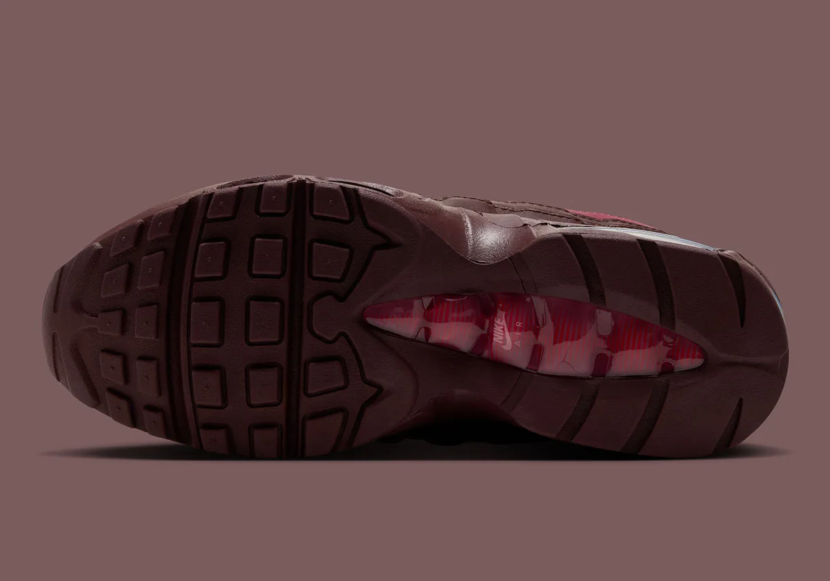 Outsole view in dark brown with square tread and red-pink air window with Nike Air, Mystic Dates