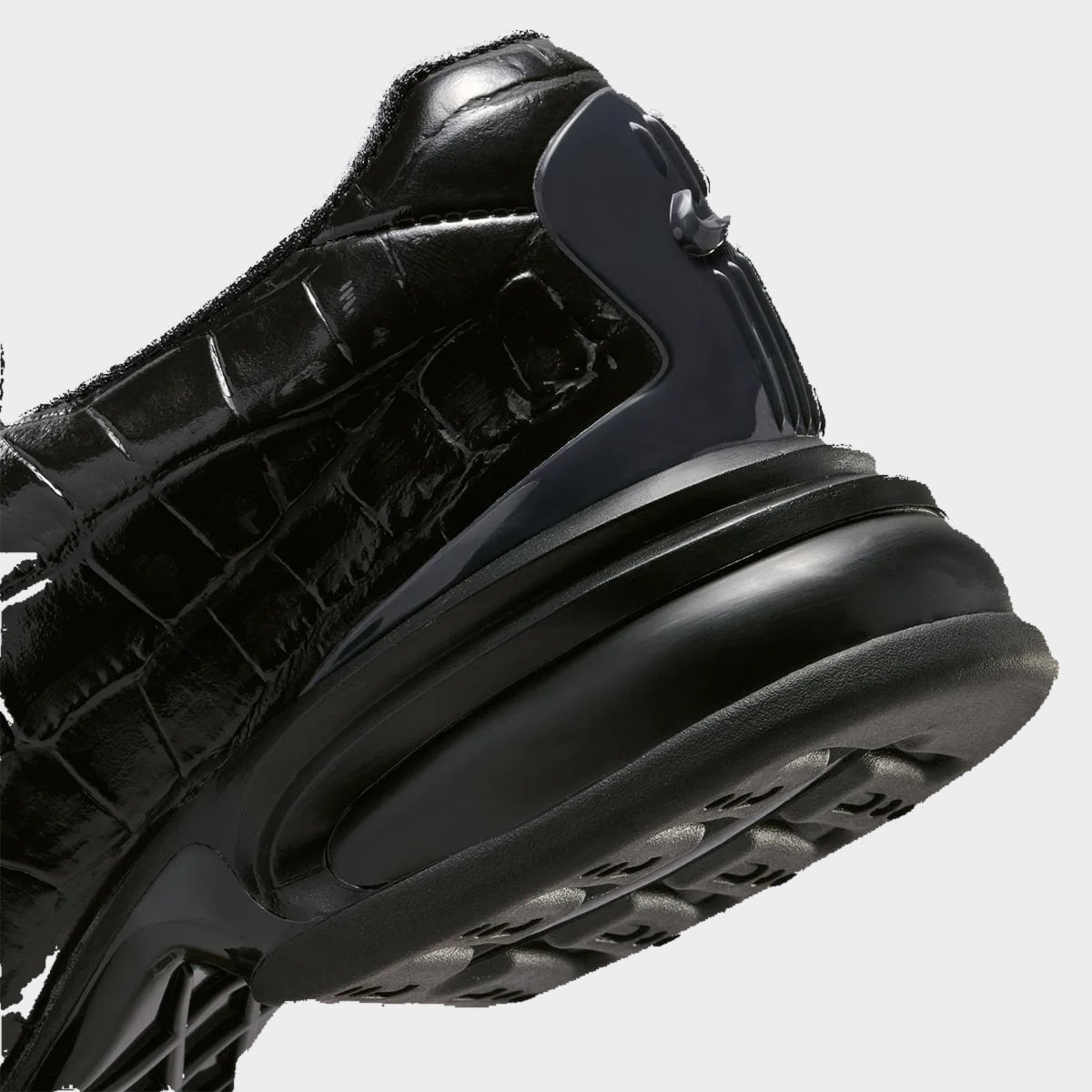 Heel detail of black croc leather, dark grey heel clip with Swoosh, black sole, Pearl Pink