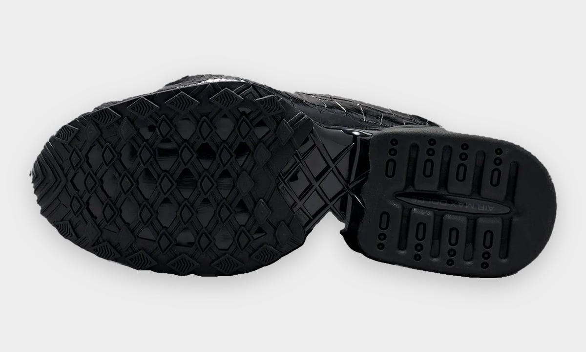 Outsole view of black pair-style tread, diamond lugs, 'Air Max Dolce' text on heel, Pearl Pink