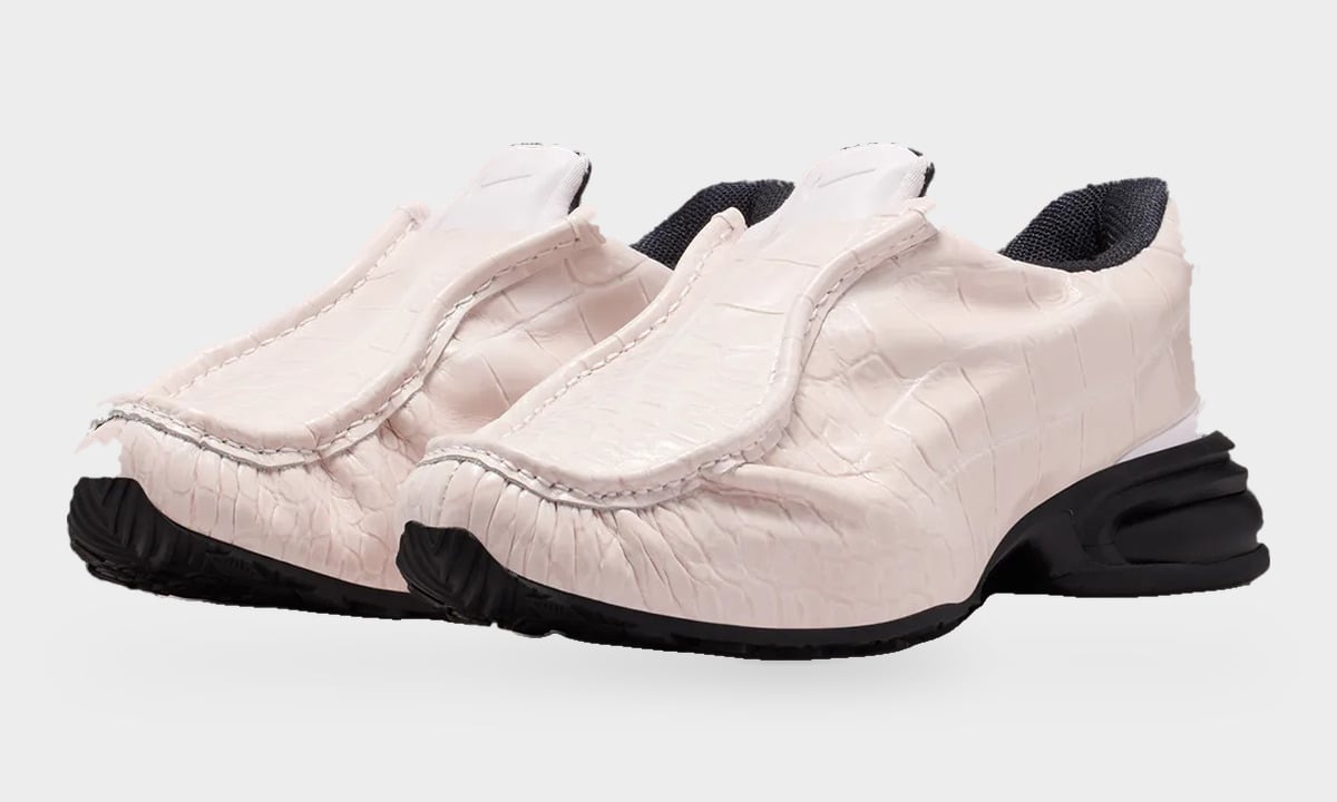 Pair, three-quarter view of pale pink croc-embossed slip-ons with black soles, Pearl Pink