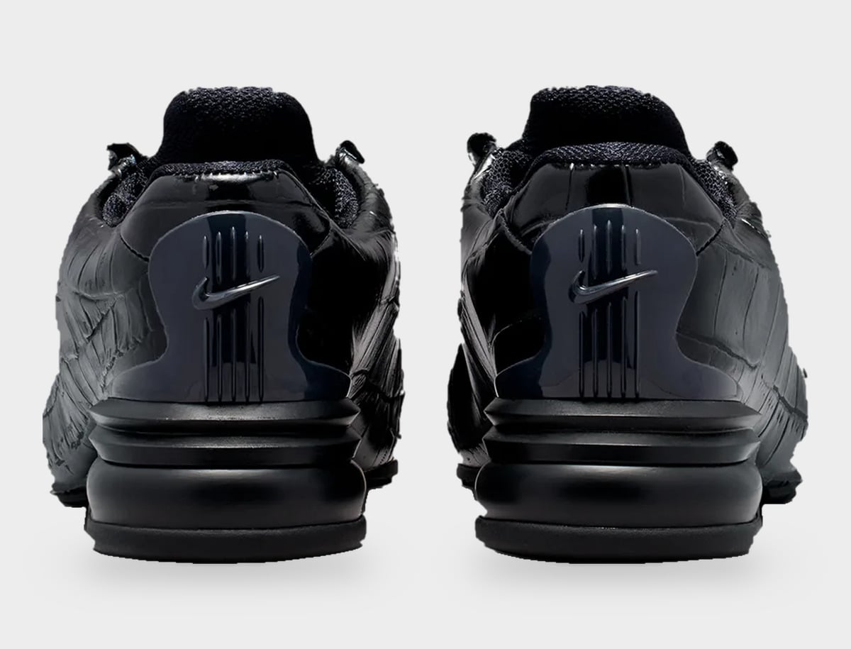 Heel view of pair in all-black glossy croc leather, dark Swoosh on heel clip, Pearl Pink