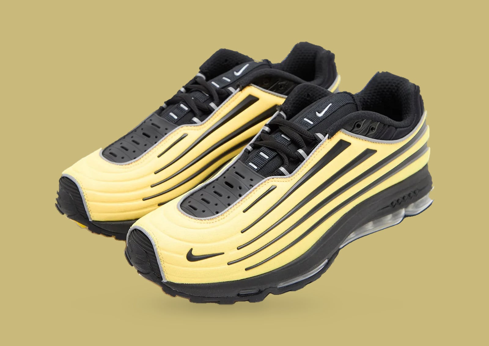 Pair in three-quarter view, yellow ridged uppers with black stripes on a tan backdrop, Nike Air Max Ecstasy Plus “Citron”