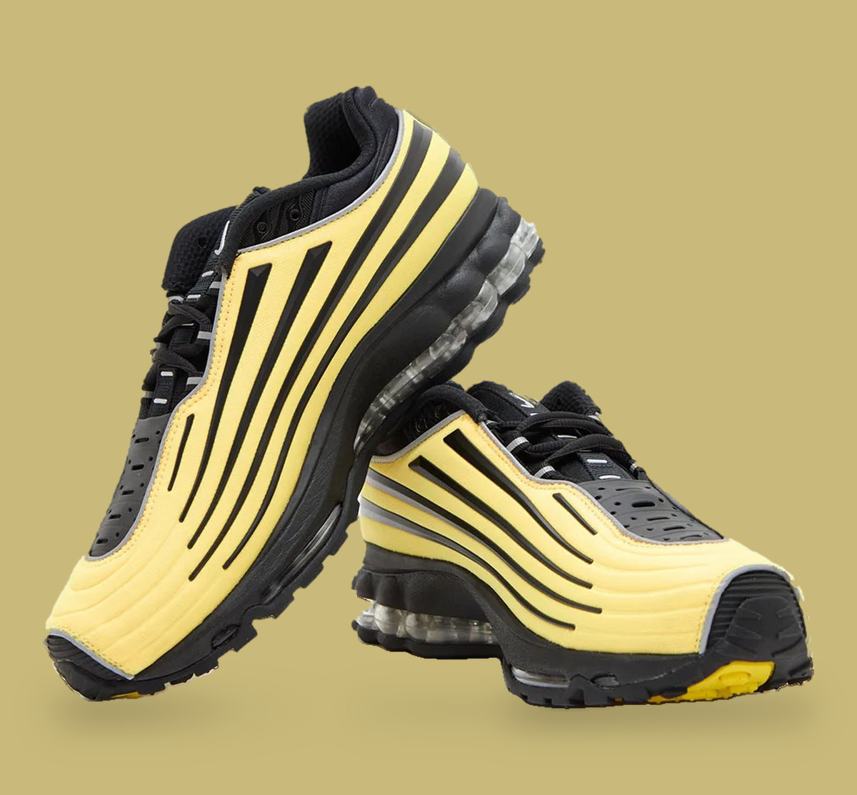 Pair stacked on tan backdrop, yellow-and-black striped uppers and a yellow outsole patch, Citron