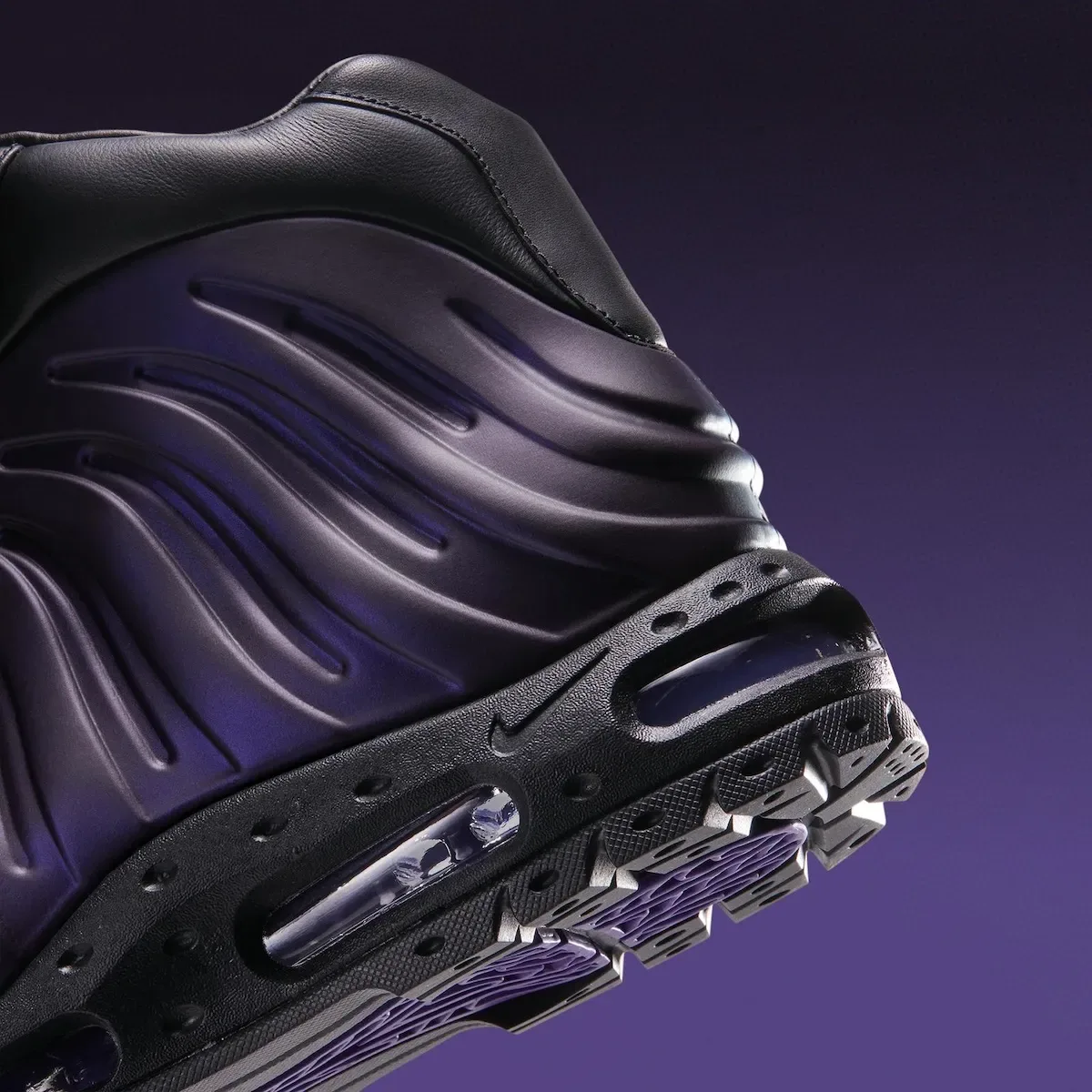 Detail of heel and sidewall: ribbed purple shell, Nike swoosh, air unit, lugged sole, Eggplant
