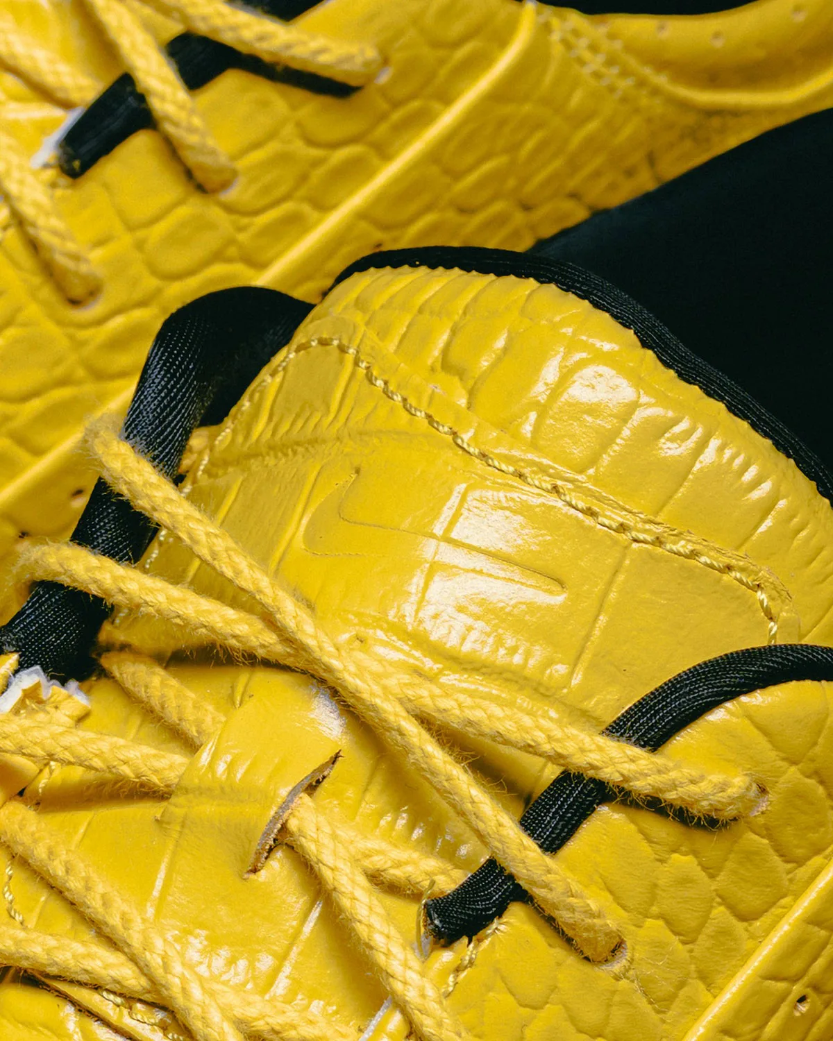 Close-up detail of yellow croc-embossed tongue, tonal swoosh, yellow laces and black lining, Vivid Sulfur