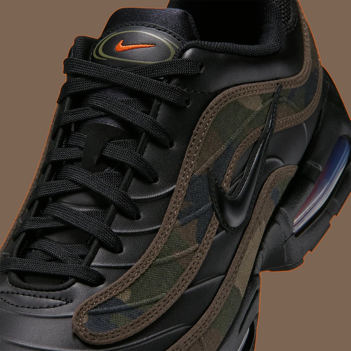 Upper detail with camouflage fabric, black Swoosh and orange tongue logo, Camo