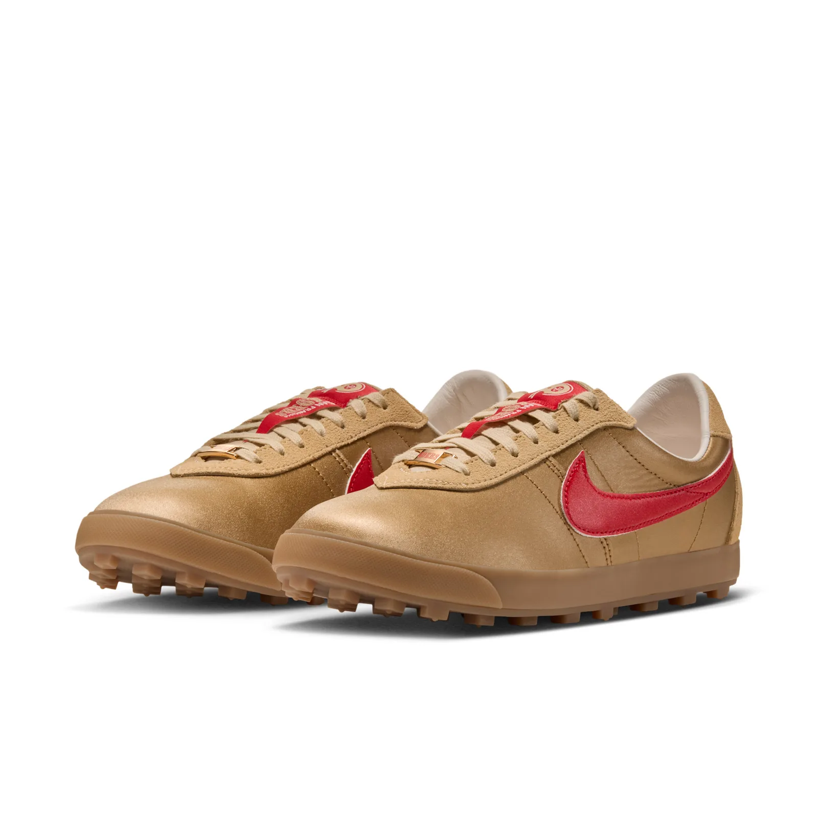 Pair at a three-quarter angle with gold satin toes, red swooshes and gold lace charms, NFL Pack