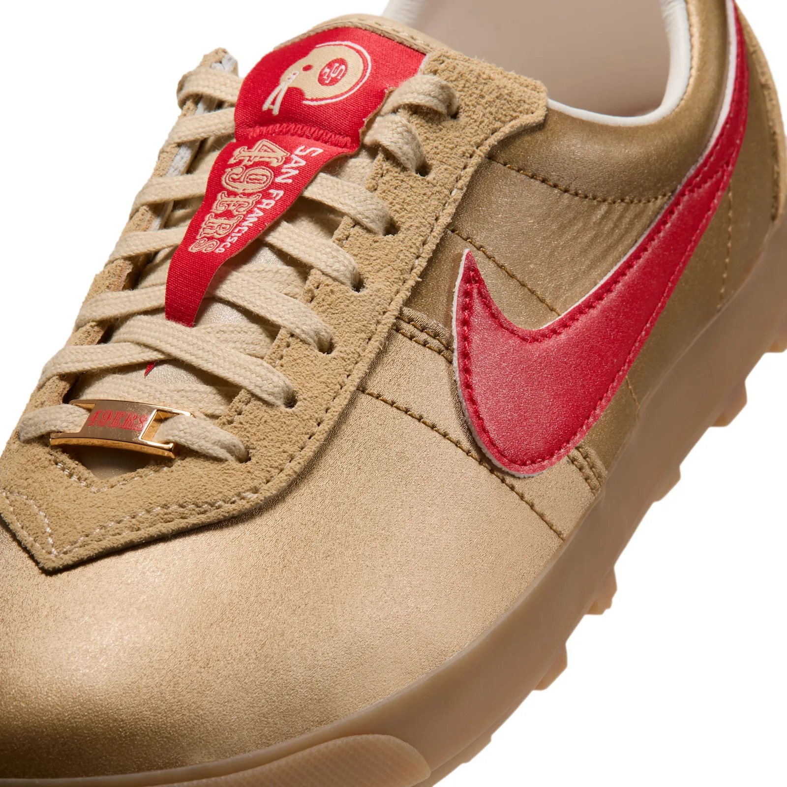Detail of the toe box with a red 49ers pennant tongue, gold lace charm and red swoosh, NFL Pack