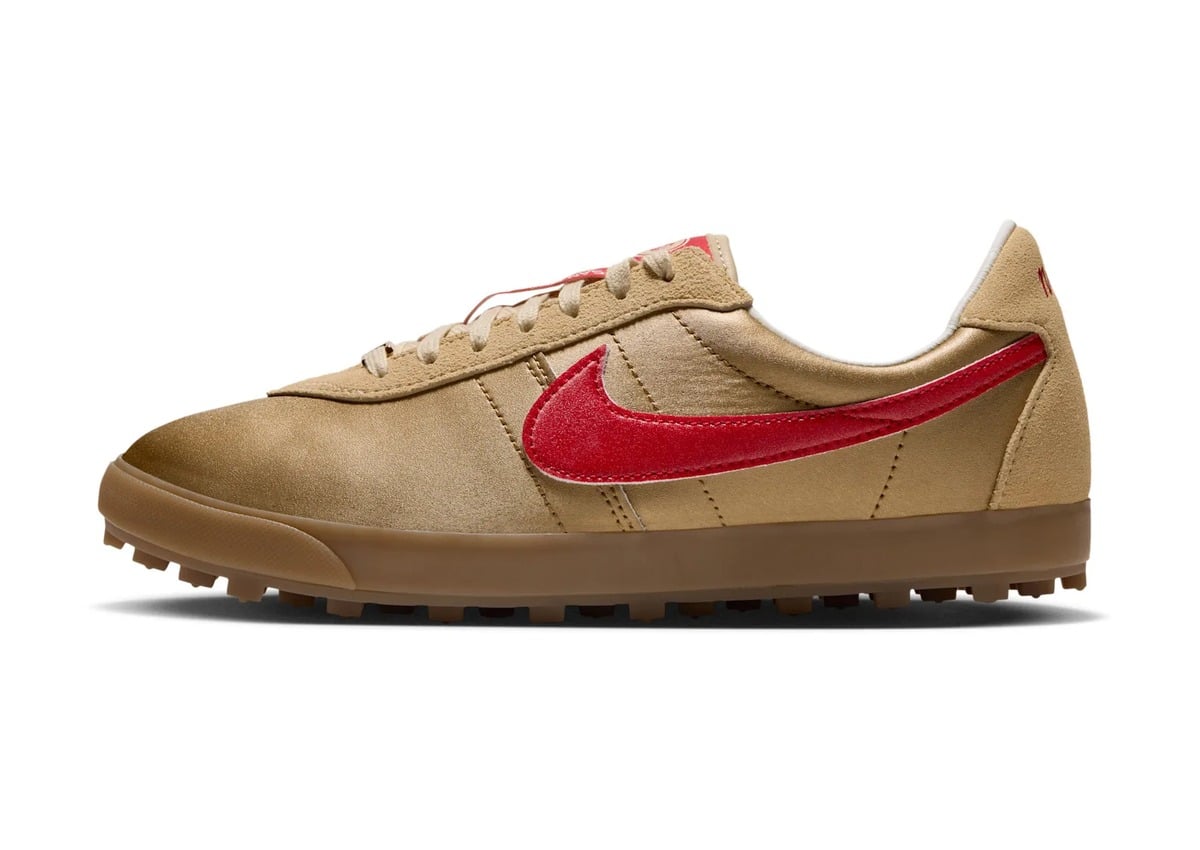 Lateral view of a gold satin sneaker with a red suede swoosh and gum studded sole, Nike Astrograbber “NFL Pack”