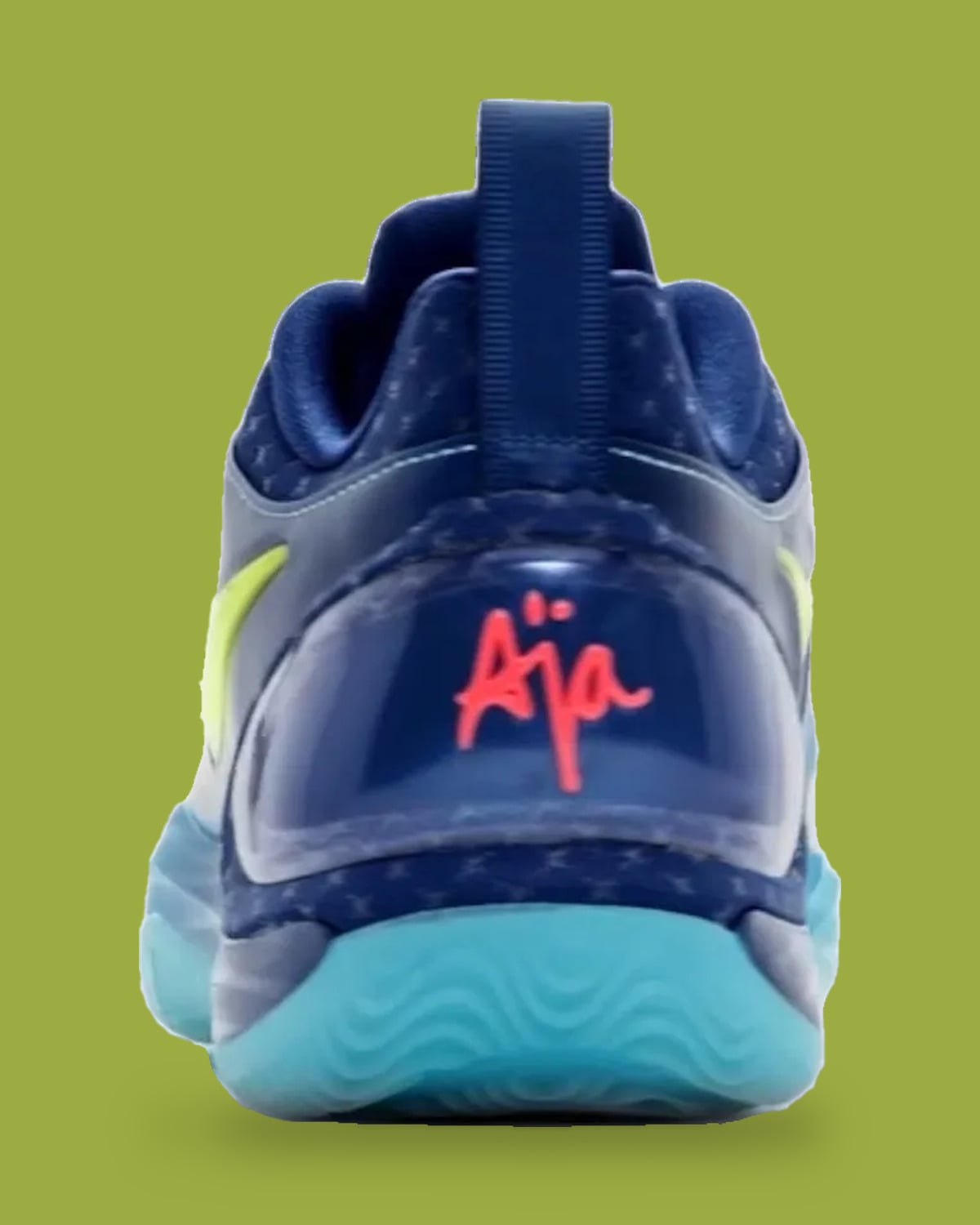 Heel view with red "Aja" script on clear navy heel counter, aqua wavy outsole, pull tab, Wheels On