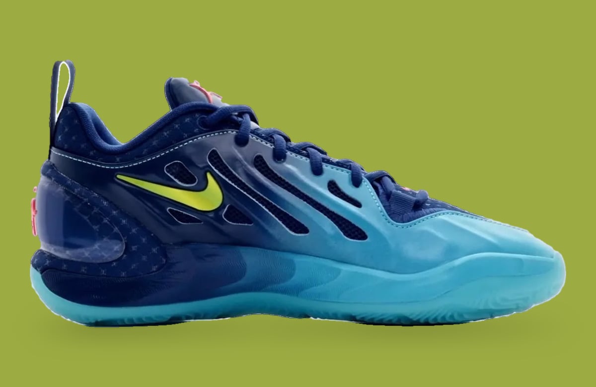 Medial view with mesh cutouts, navy to aqua gradient, small yellow swoosh and pull tab, Wheels On