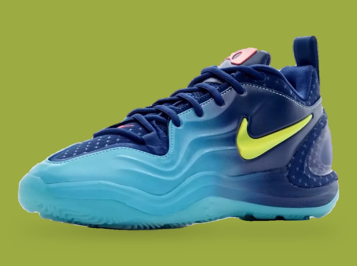 Three-quarter toe view of navy and aqua sneaker with yellow swoosh, star-dotted mesh, olive backdrop, Wheels On