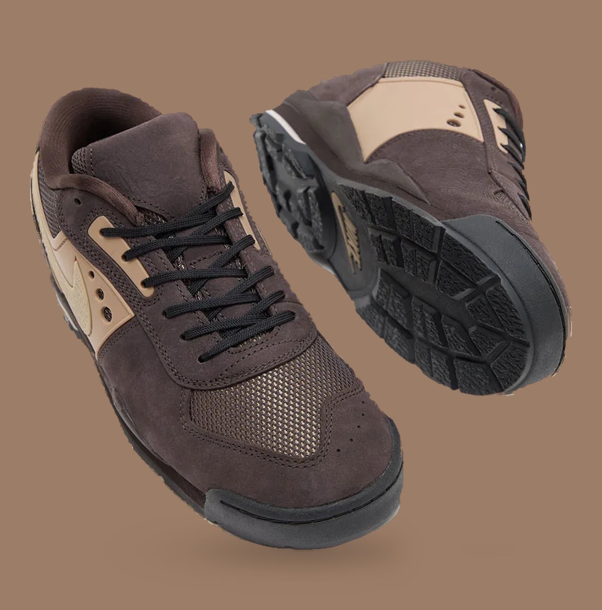 Brown pair, one on its side showing black lugged outsole, tan side panels, Nike Baltoro Low