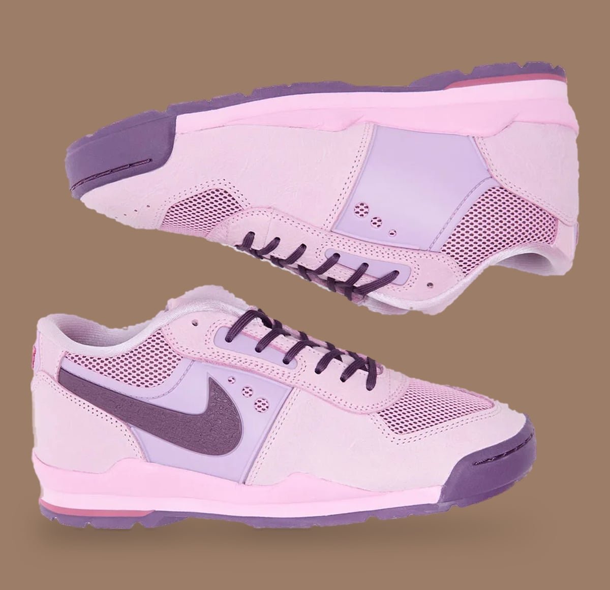 Pink pair, one on its side showing sole, dark purple Swoosh and laces, Nike Baltoro Low