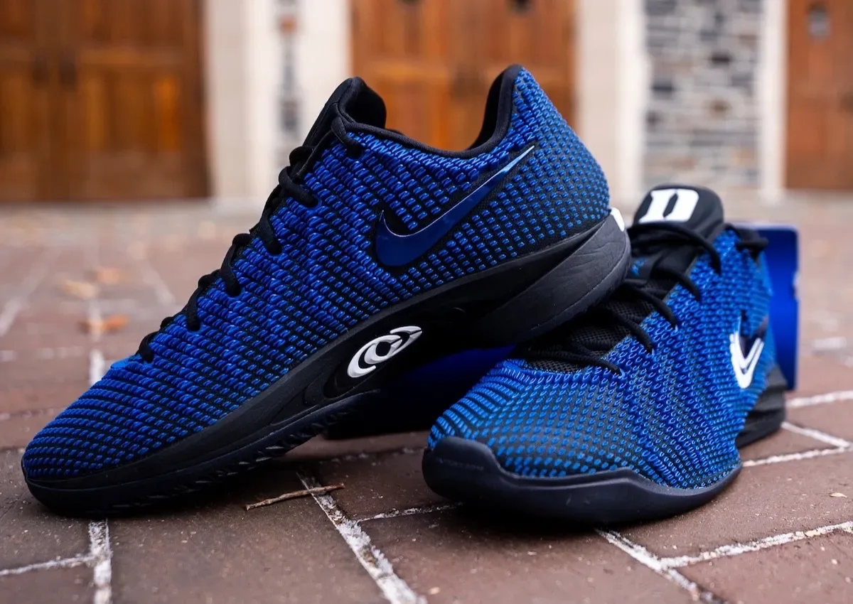 Pair on brick paving, blue knit uppers, black midsoles, white Duke D on tongue, Duke