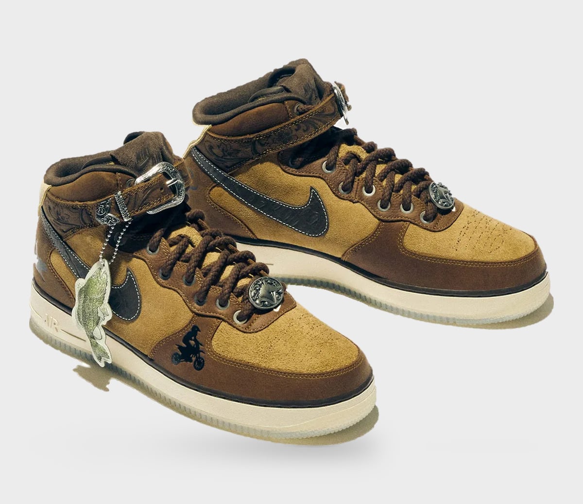 Pair of brown mid-tops in tan suede, buckled ankle straps, concho lace studs and a fish tag, Freestyle 2027 Collection