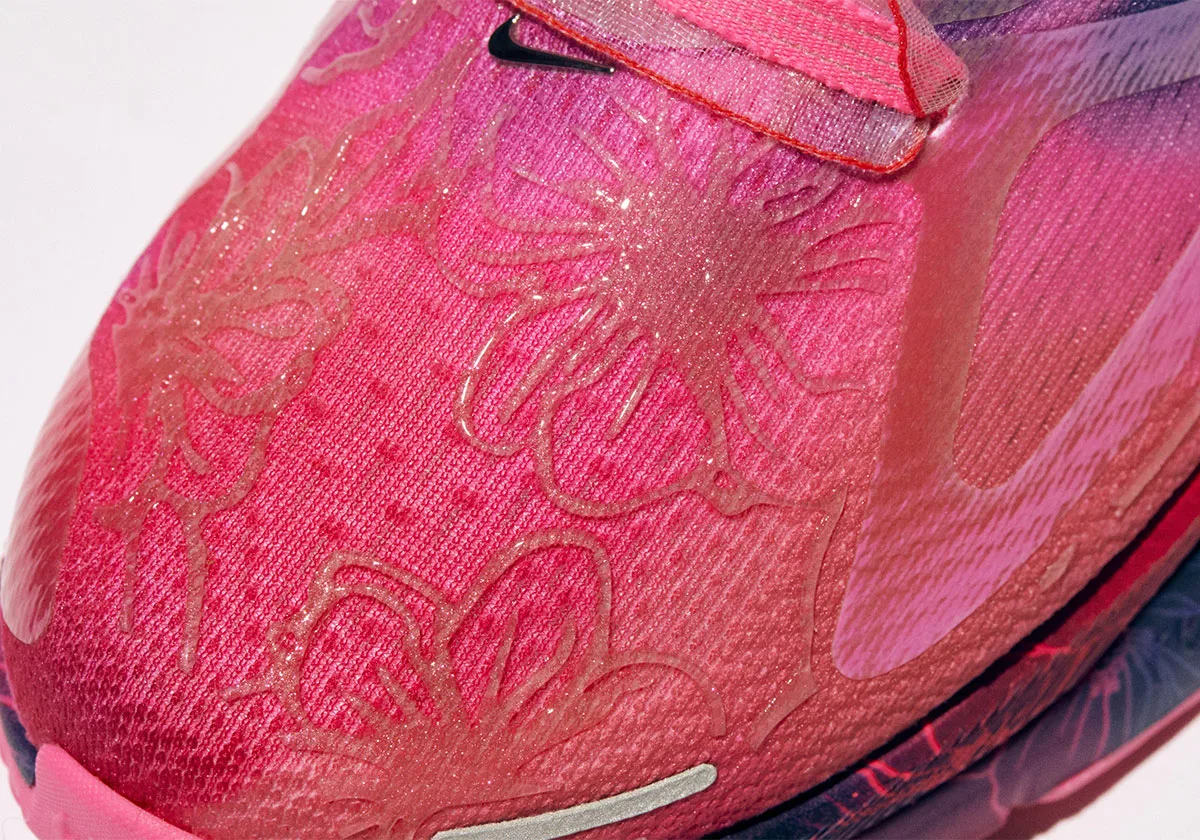 Detail of a pink toe box with raised floral outlines, glittery texture and chrome swoosh, Freestyle 2027 Collection