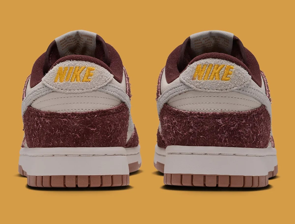 Heel view of a pair, yellow Nike embroidery on grey suede tabs, burgundy suede heels, Basketball Charm