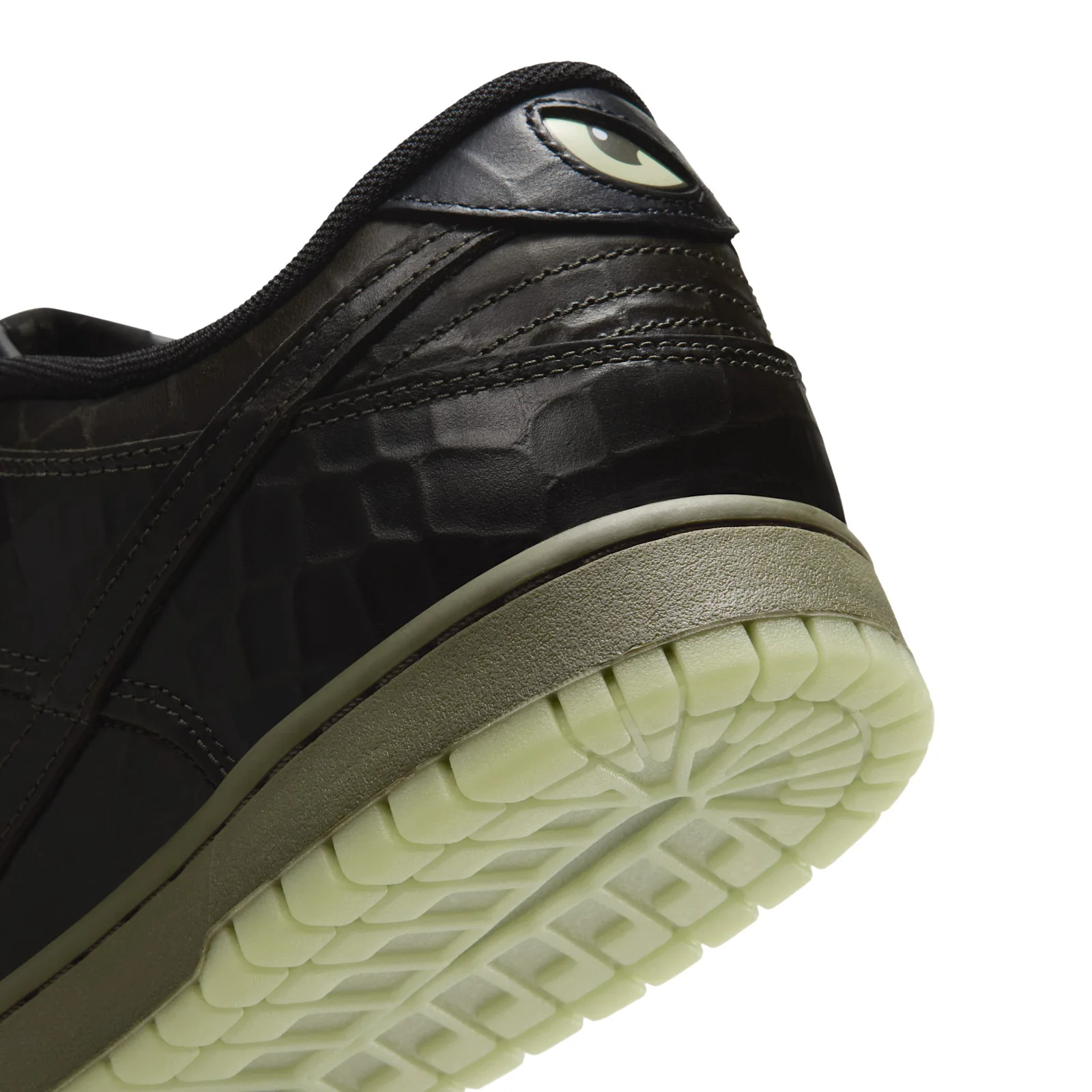 Heel detail with a pale green eye graphic and reptile-textured black upper, Halloween