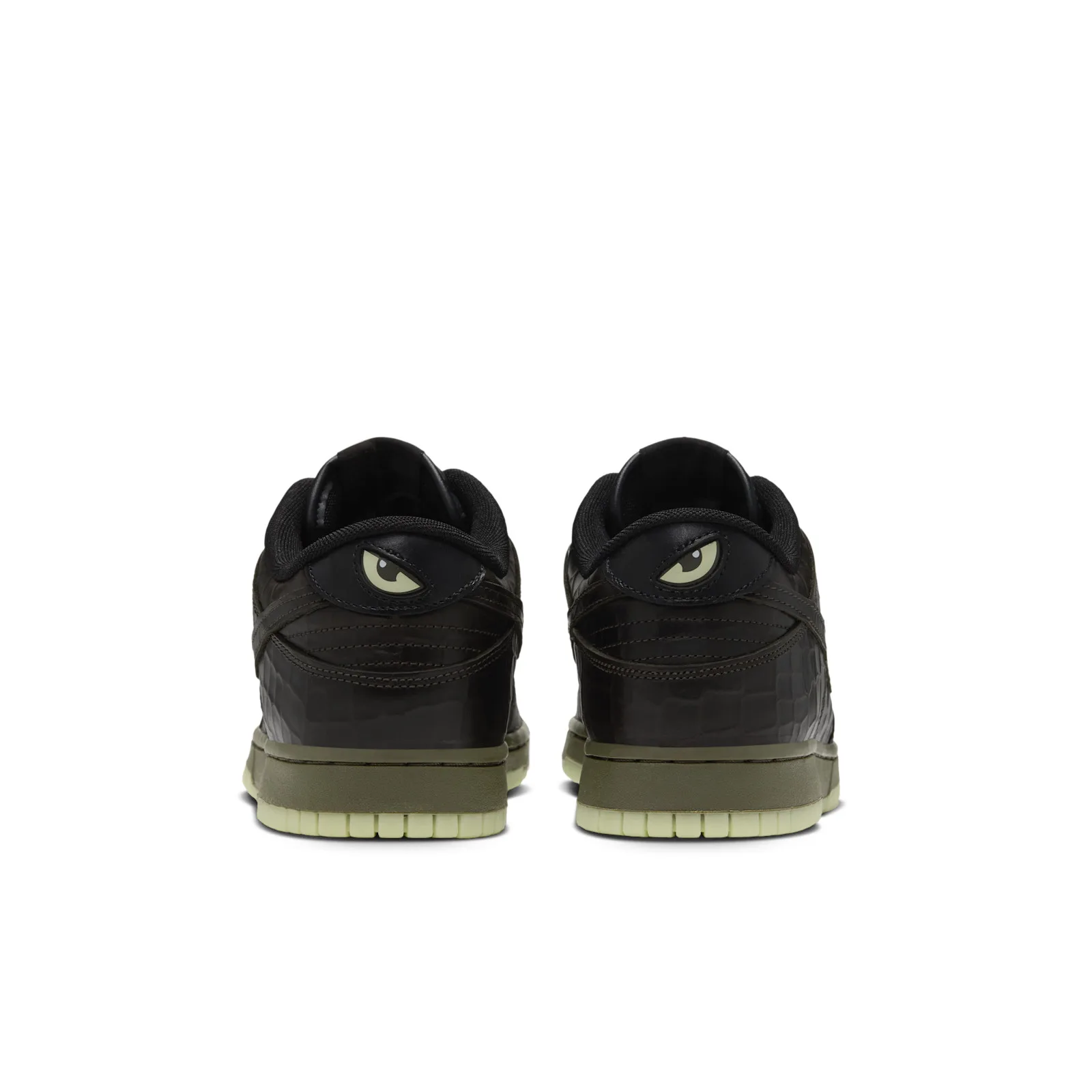 Heel view of the pair with pale green eye graphics and olive midsoles, Halloween