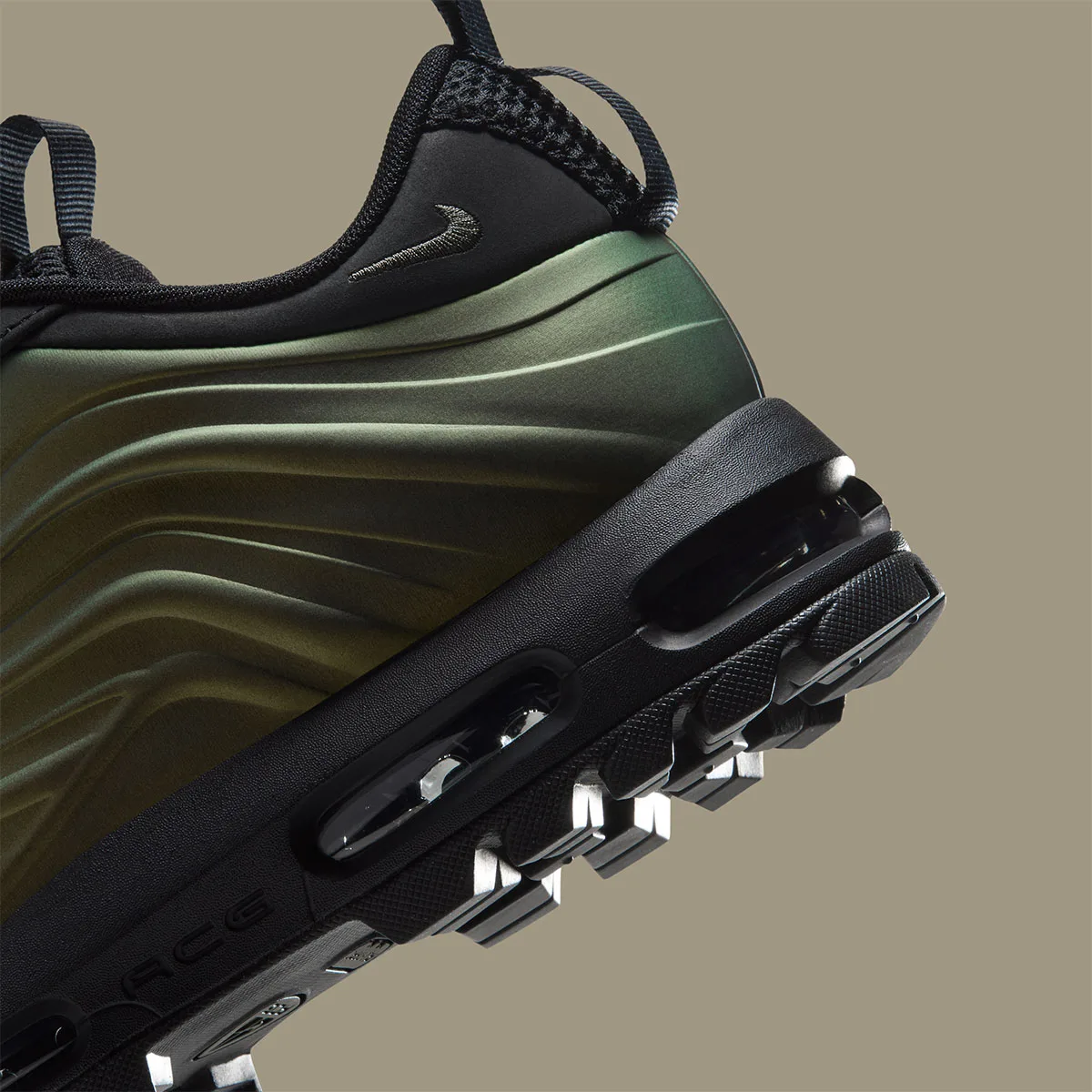 Detail of heel, iridescent green ridged shell, black air unit and ACG text, Metallic Gold