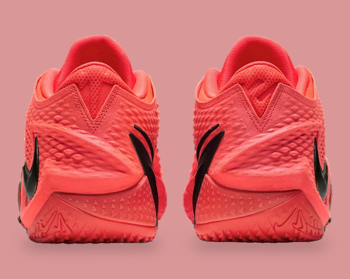 Heel view of pair with coral textured uppers and embossed outsole logos, Code Red