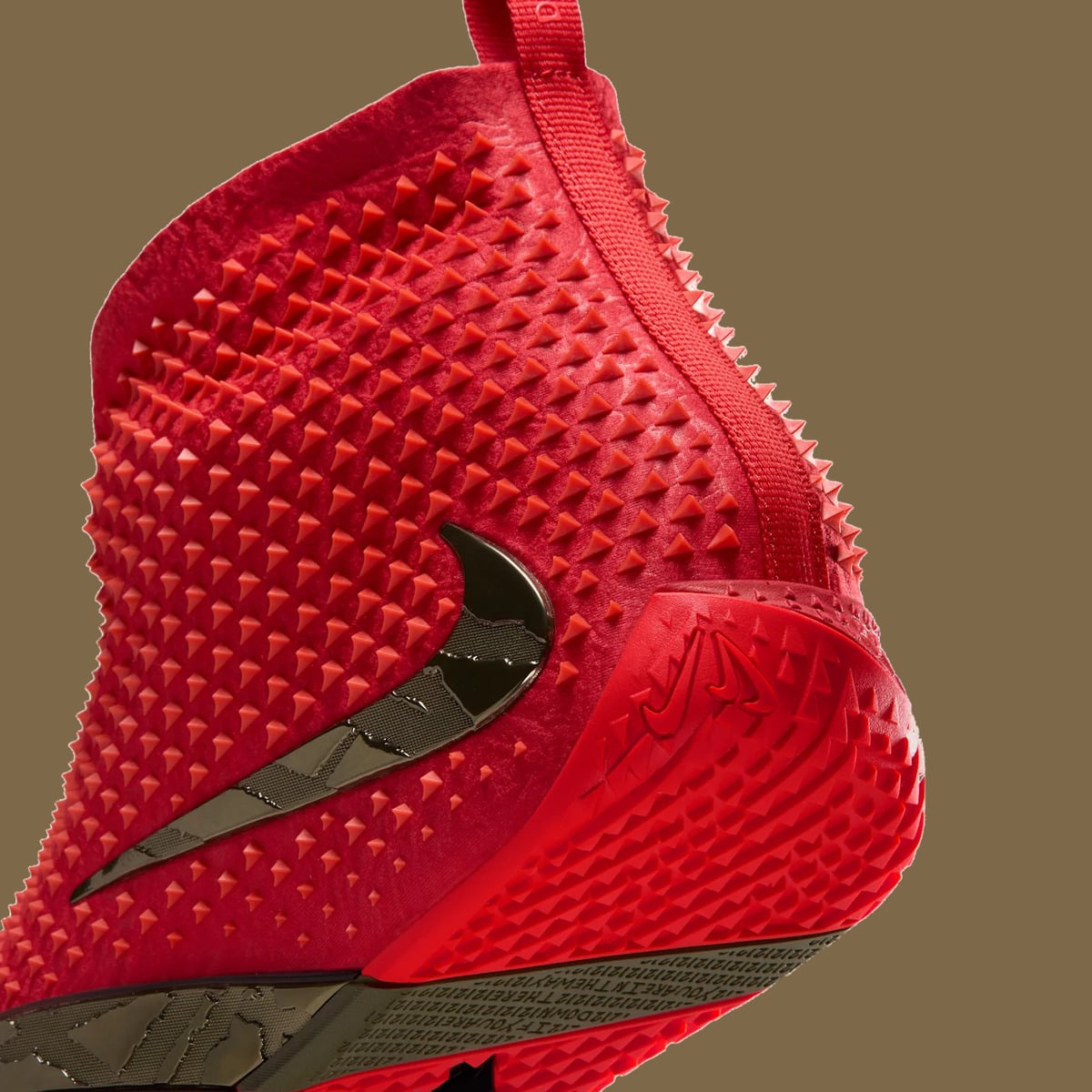 Detail of rear heel with red spikes, bronze swoosh and red pyramid-tread outsole, Zombie