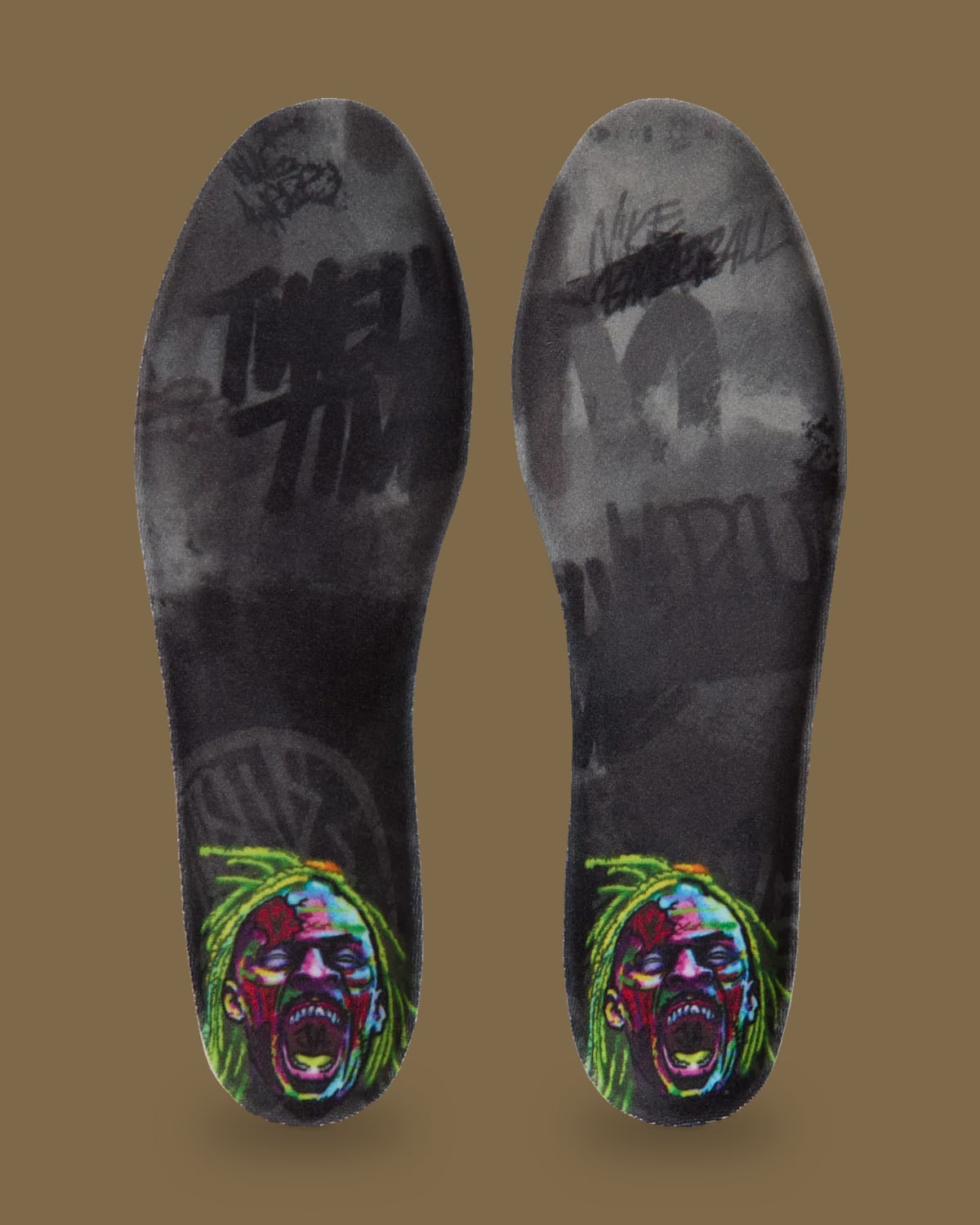 Pair of insoles with a colourful screaming zombie face and dark grey graffiti-style text, Zombie