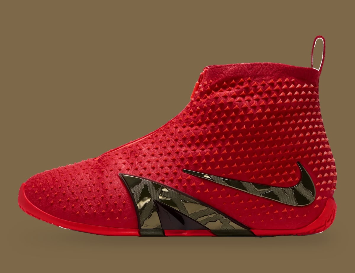 Lateral view of red spiked high-top with metallic bronze swoosh and heel pull tab, Zombie