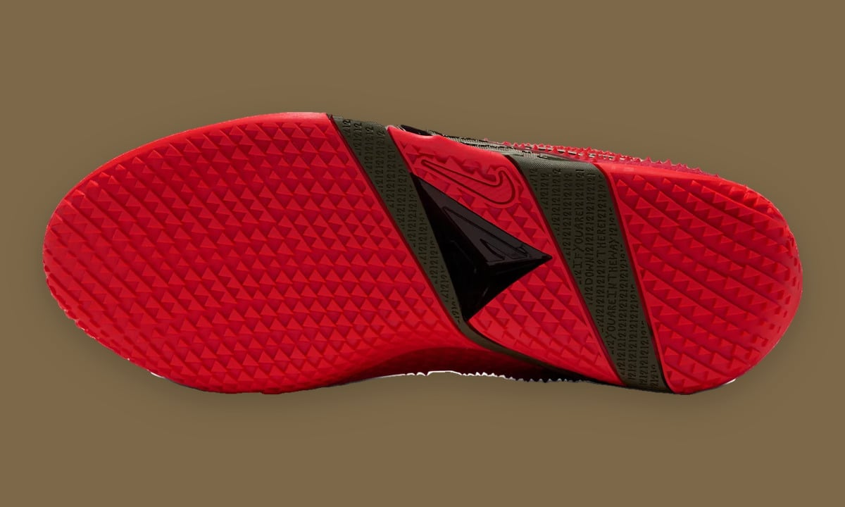 Outsole view of red pyramid-tread sole with olive bands of small text and black triangle, Zombie