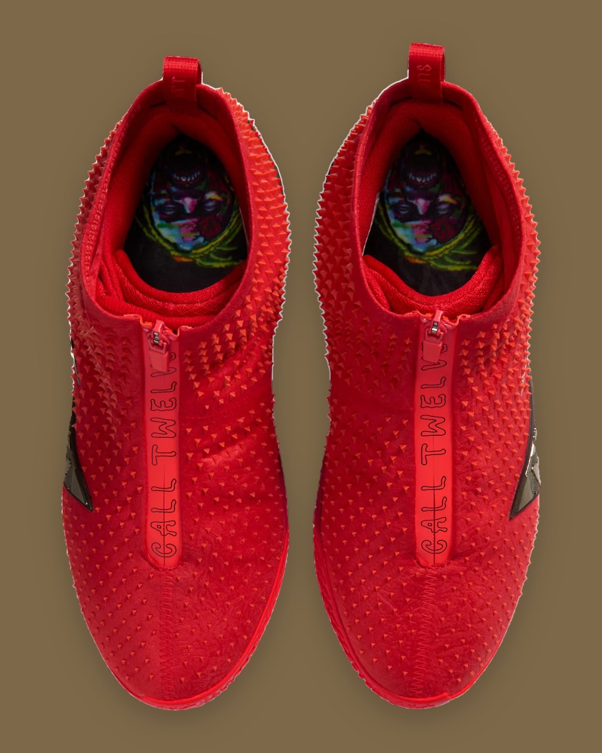 Top-down view of pair with "call twelve" zip text and colourful zombie face insoles, Zombie