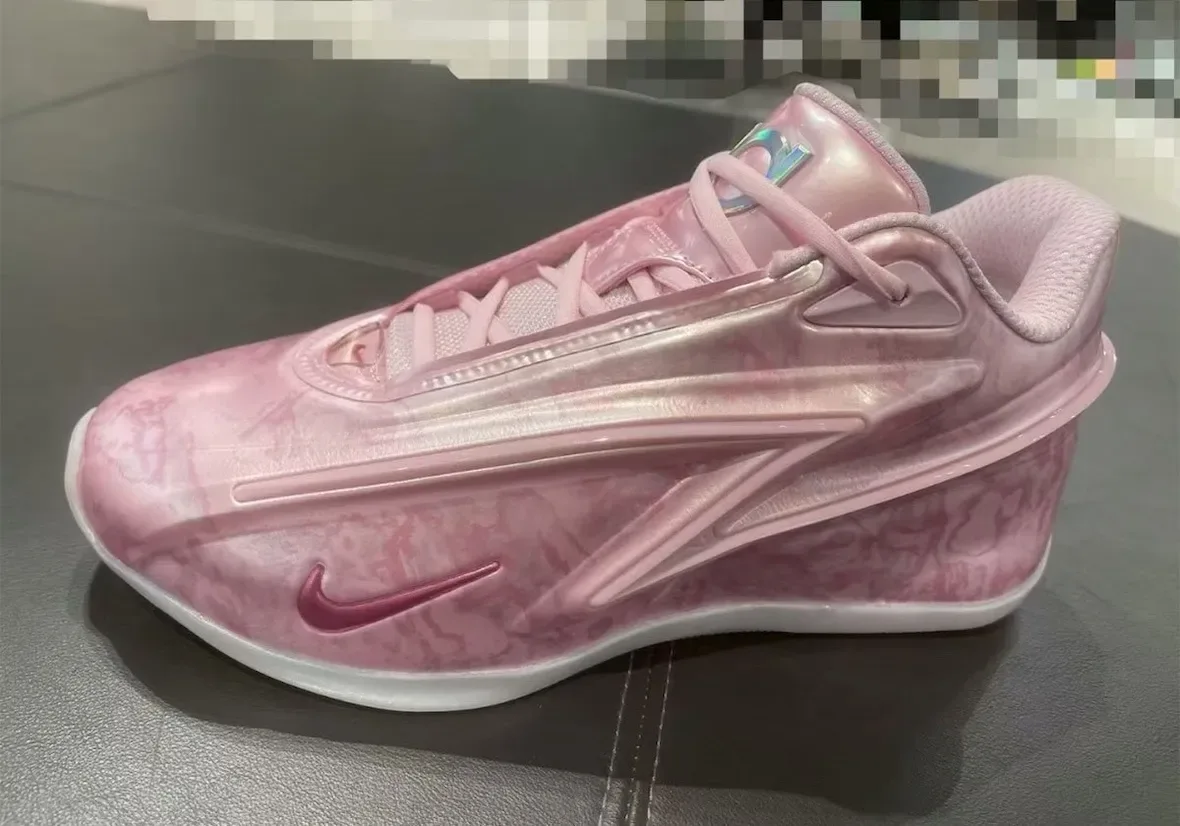 Lateral view of a pink marbled glossy shoe with magenta swoosh, pink laces and an iridescent tongue tag, Aunt Pearl