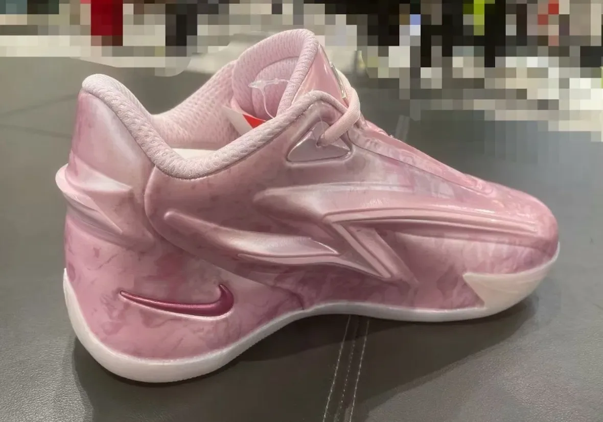 Lateral view from the heel of a glossy pink marbled shoe, magenta swoosh, white midsole, pixelated backdrop, Aunt Pearl