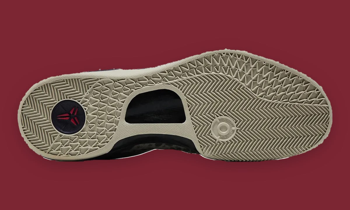 Outsole view on maroon, cream herringbone tread, round logo disc, cutout shank, Mine Grey