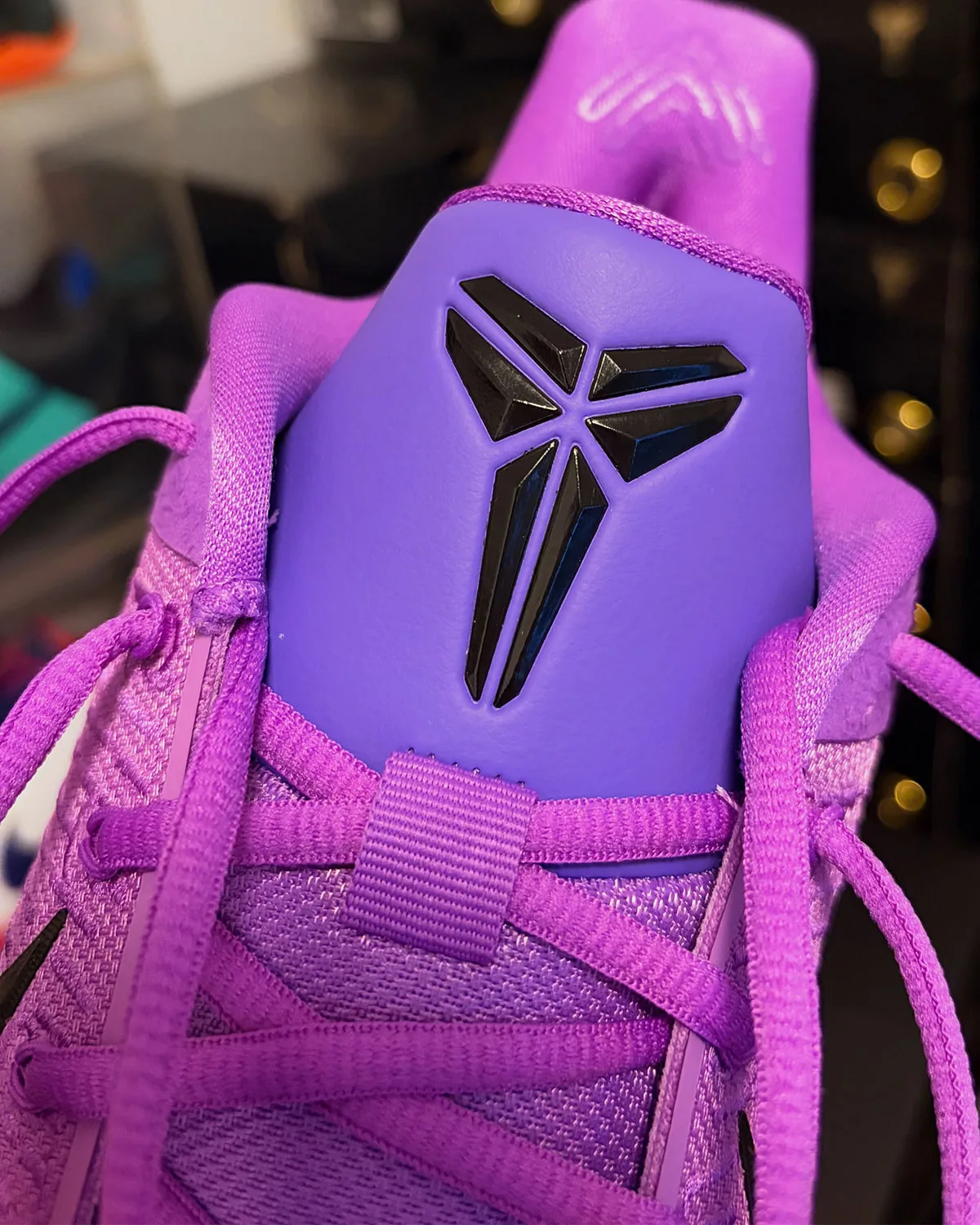 Close-up of black Kobe sheath logo on purple tongue patch, knit collar, Purple Stardust