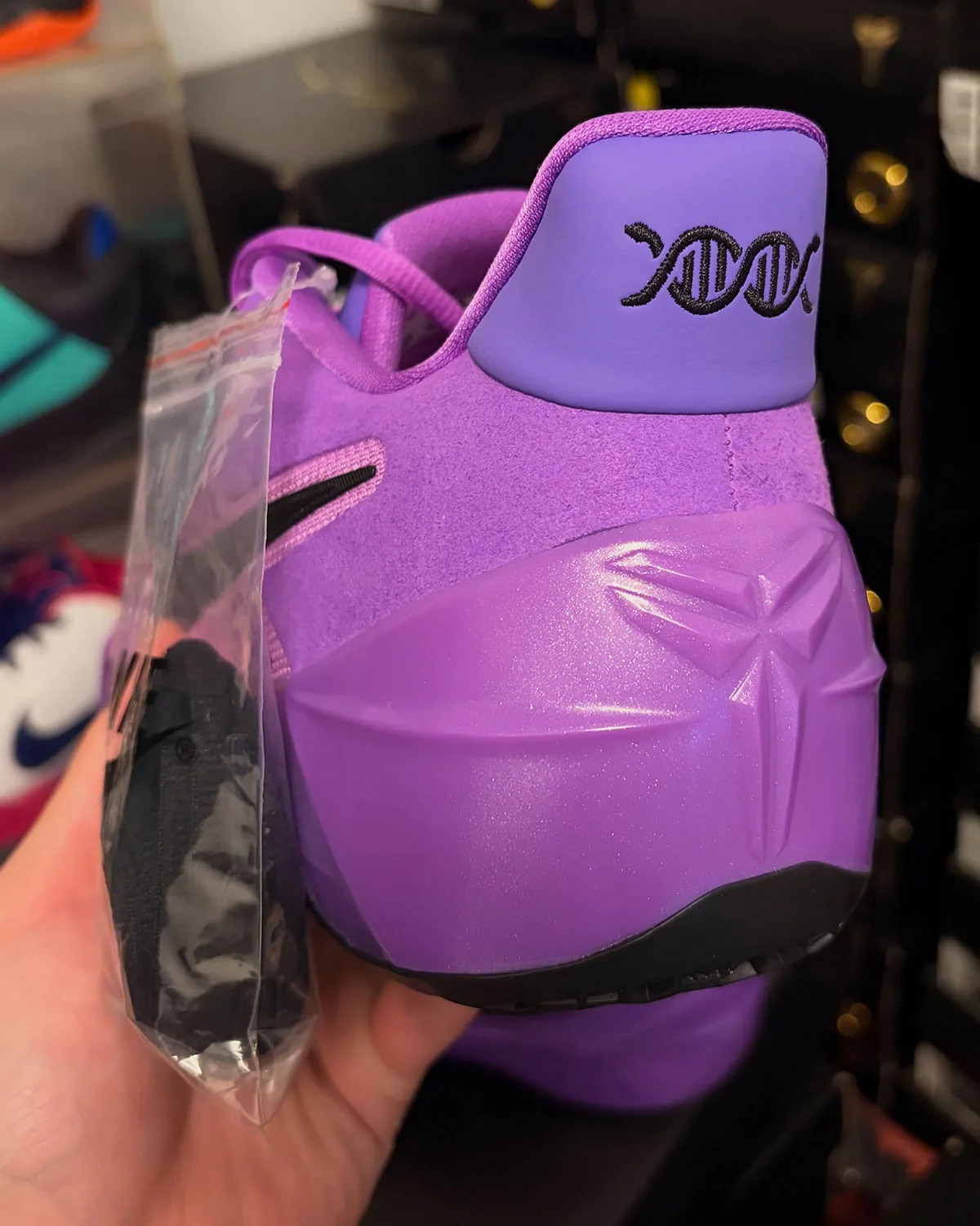 Heel view, purple pull tab with black DNA-strand logo, glossy molded heel counter, Purple Stardust