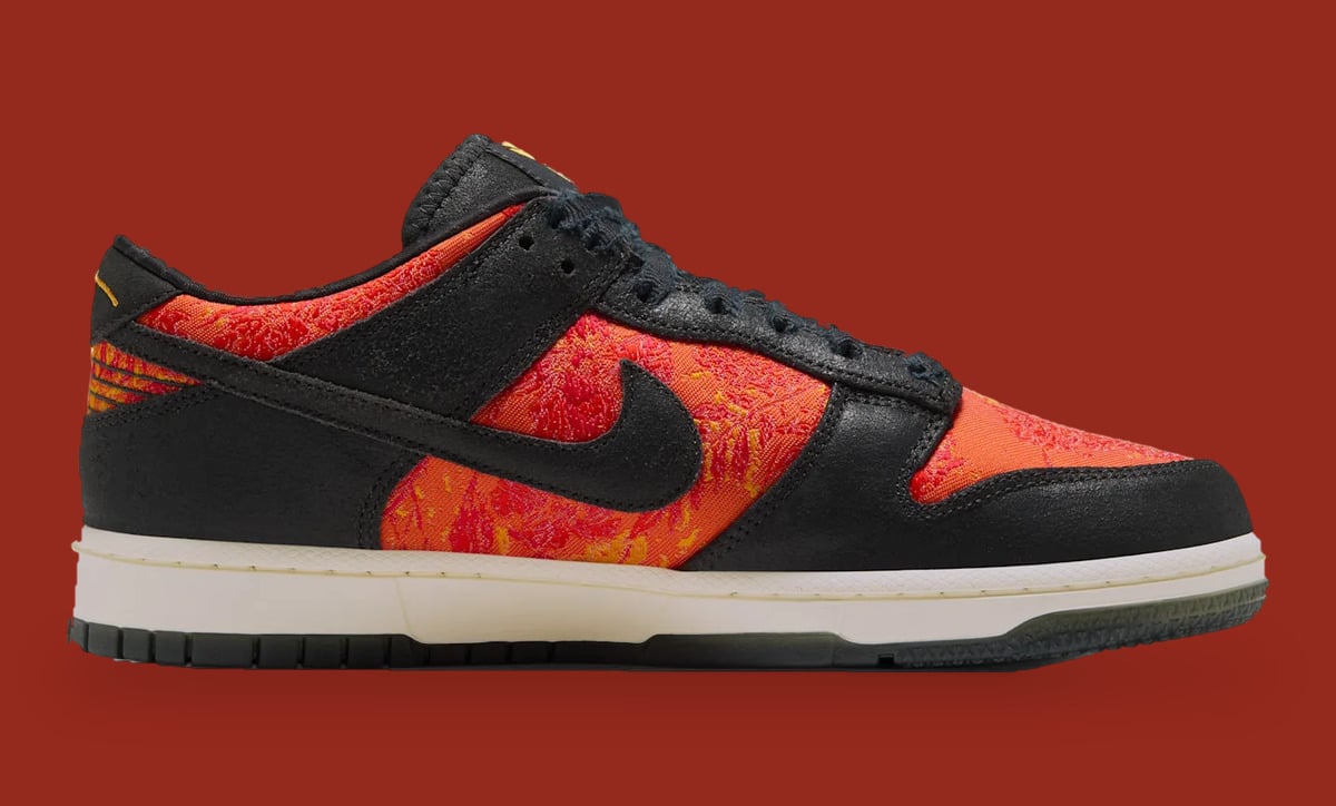 Medial view, black swoosh on red-orange patterned weave, cream midsole, dark green-grey outsole, Mamba Eterno